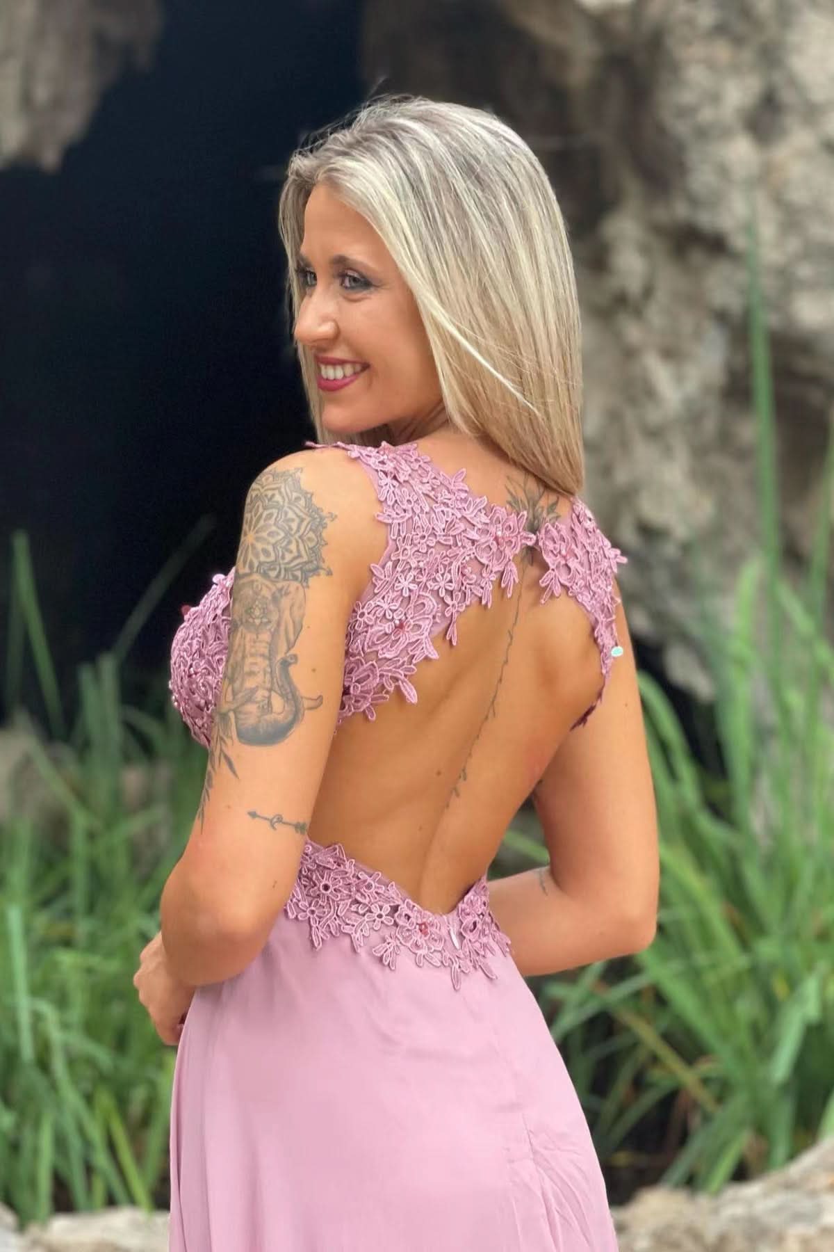Close-up of the V-neckline and delicate appliqués on the red prom dress.