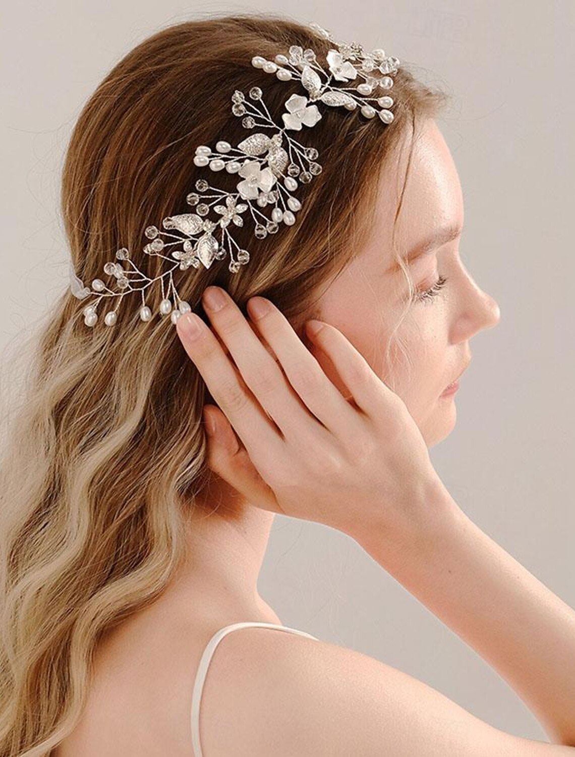 Model wearing a vintage rhinestone and faux pearl wedding tiara headband.