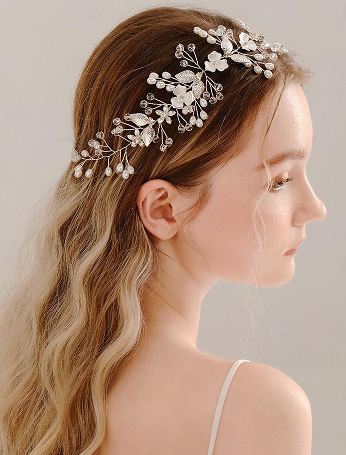 Close-up of the intricate rhinestone and faux pearl details on the tiara headband.