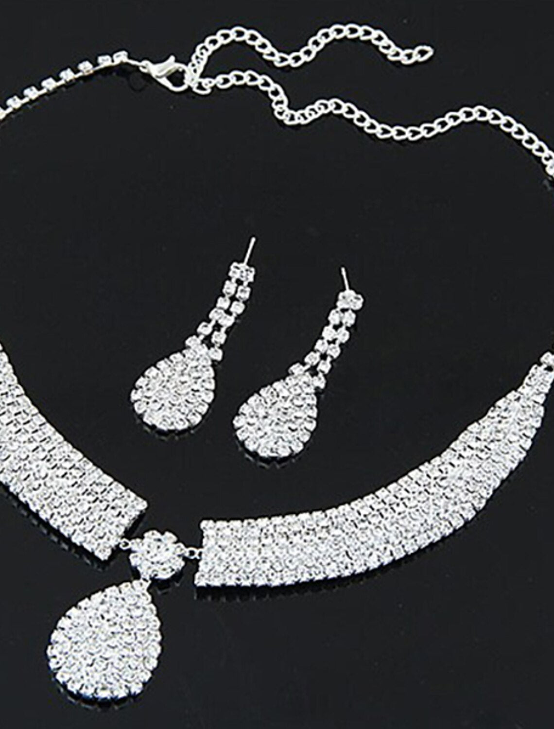 Close-up of vintage synthetic diamond and rhinestone drop earrings.