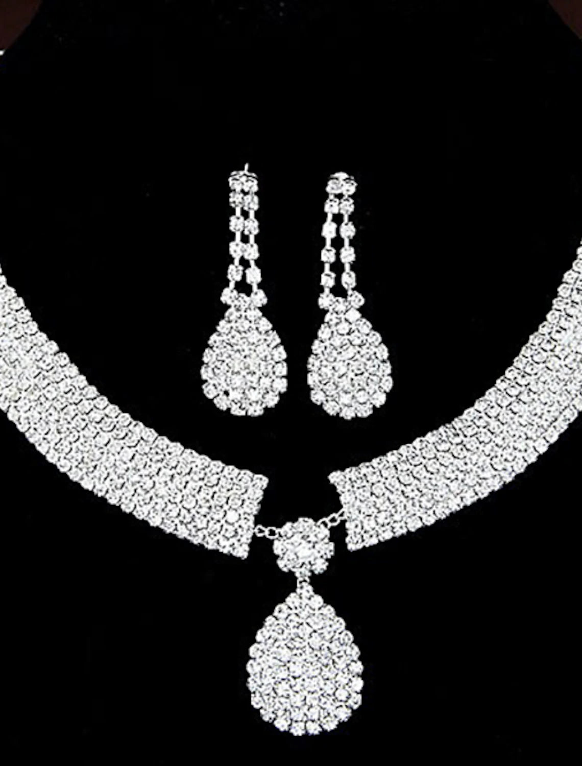 Detailed view of vintage geometric link and chain design on jewelry set.