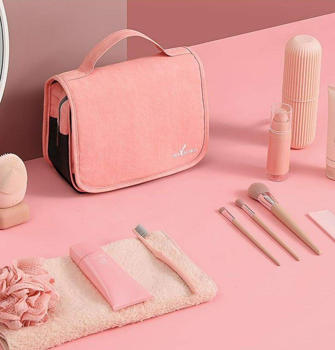 Toiletry bag hanging open, displaying organized compartments for travel essentials.