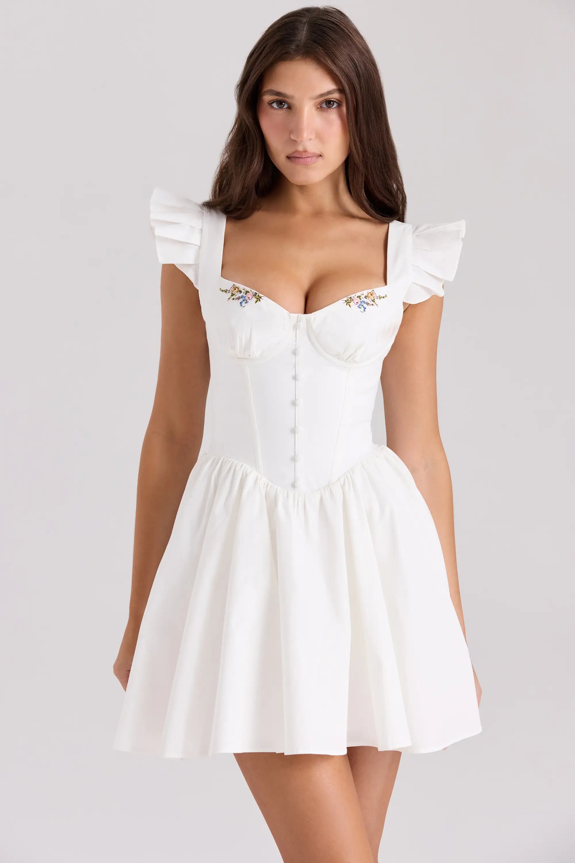 White floral embroidered corset mini dress with ruffle straps.