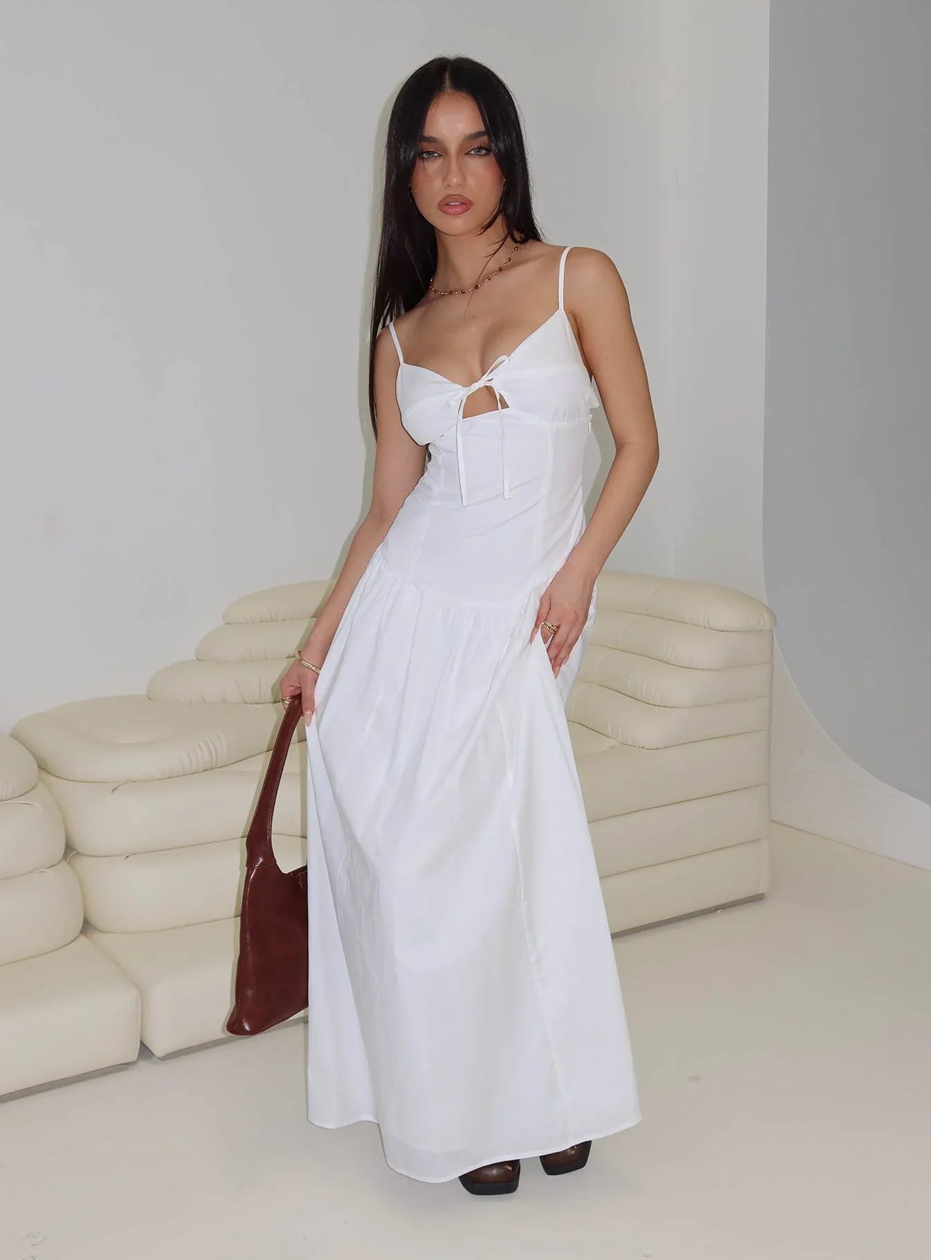White Spaghetti Strap Prom Dress with Bow Detail and Flowy Skirt for Formal Events and Prom Nights
