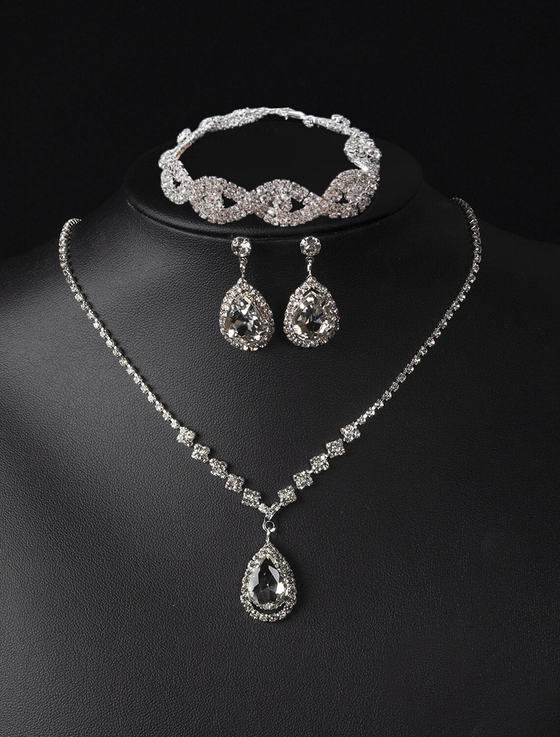 Elegant alloy water drop necklace, earrings, and bracelet set.