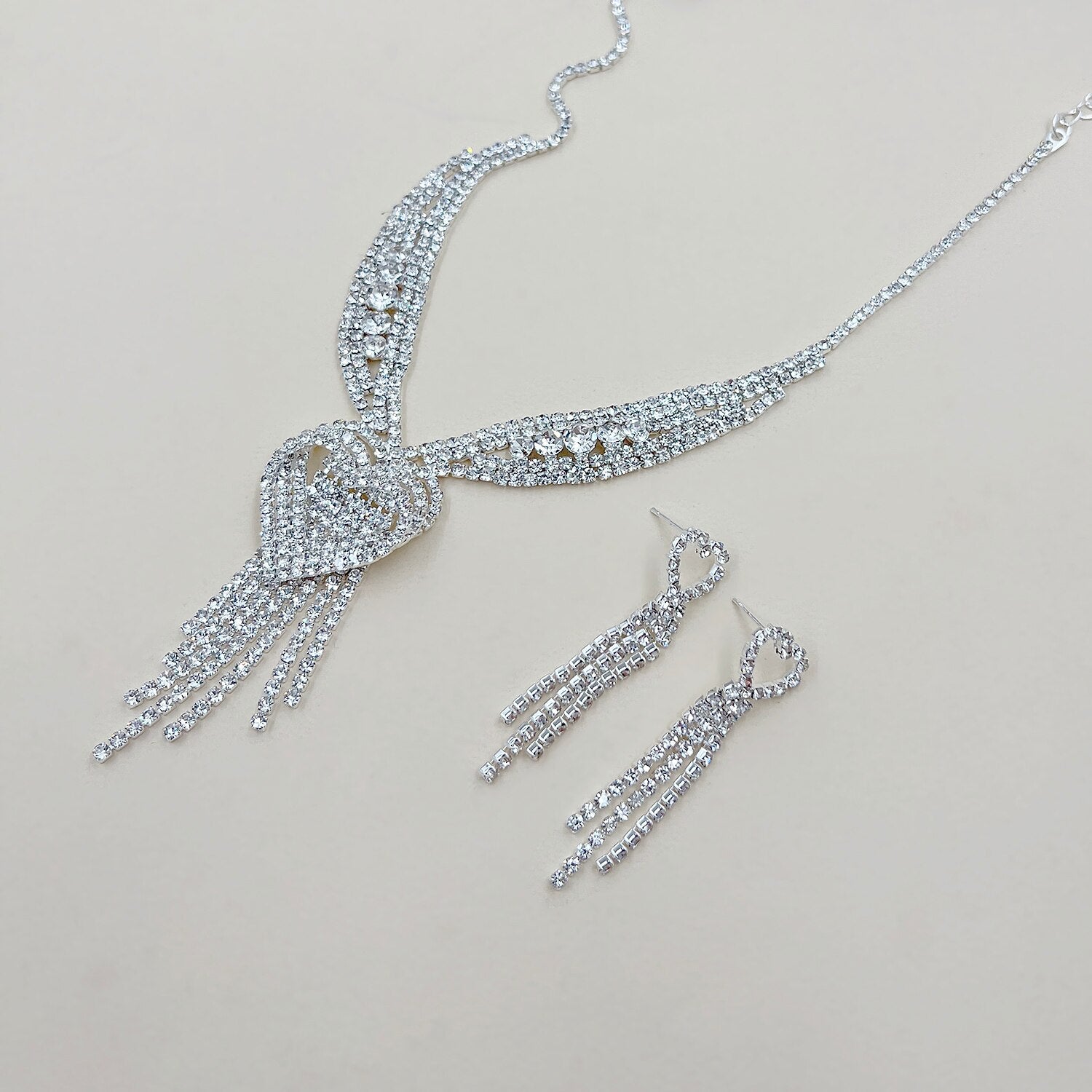 Close-up of alloy tassel earrings with heart detail.
