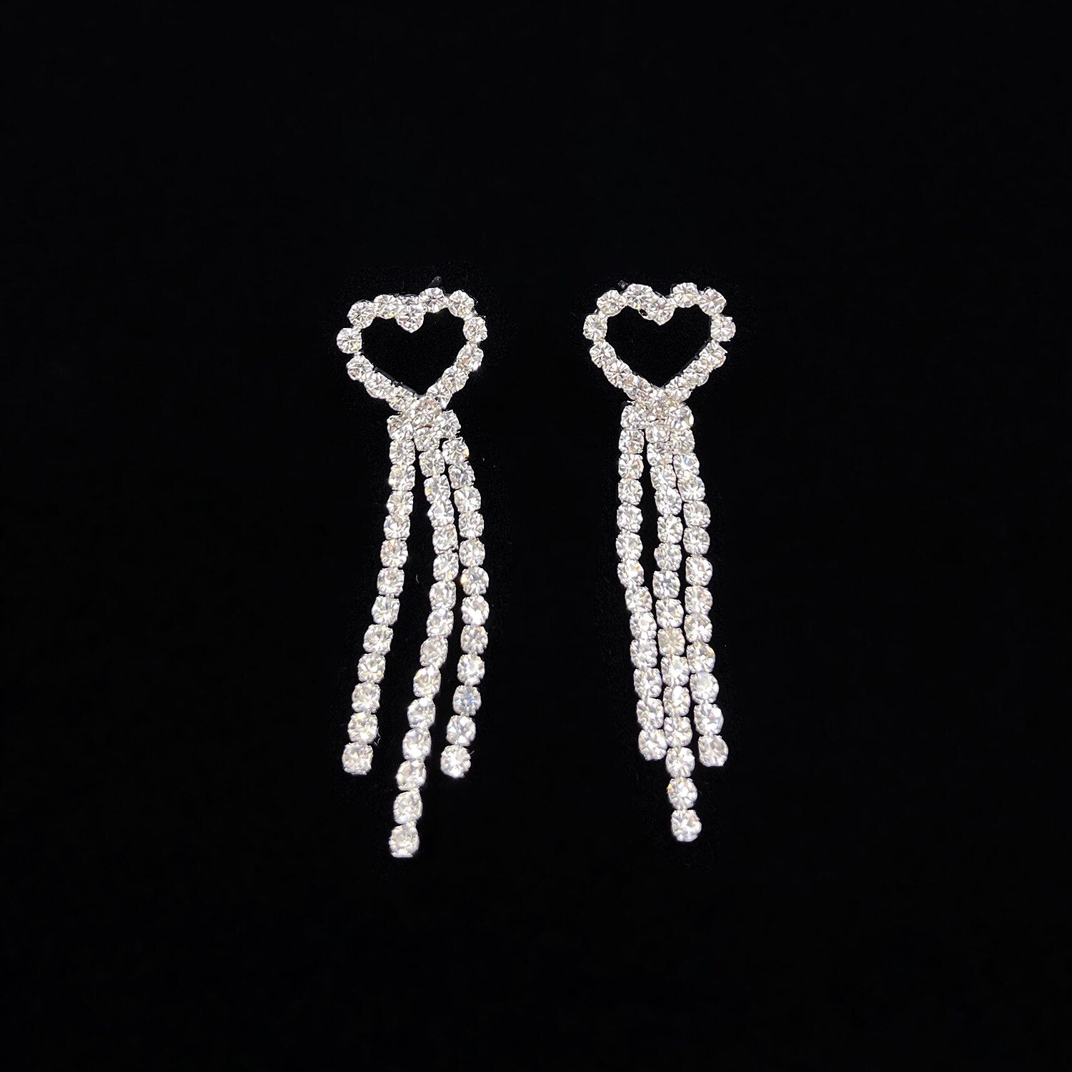 Elegant woman showcasing the bridal heart tassel jewelry set.
