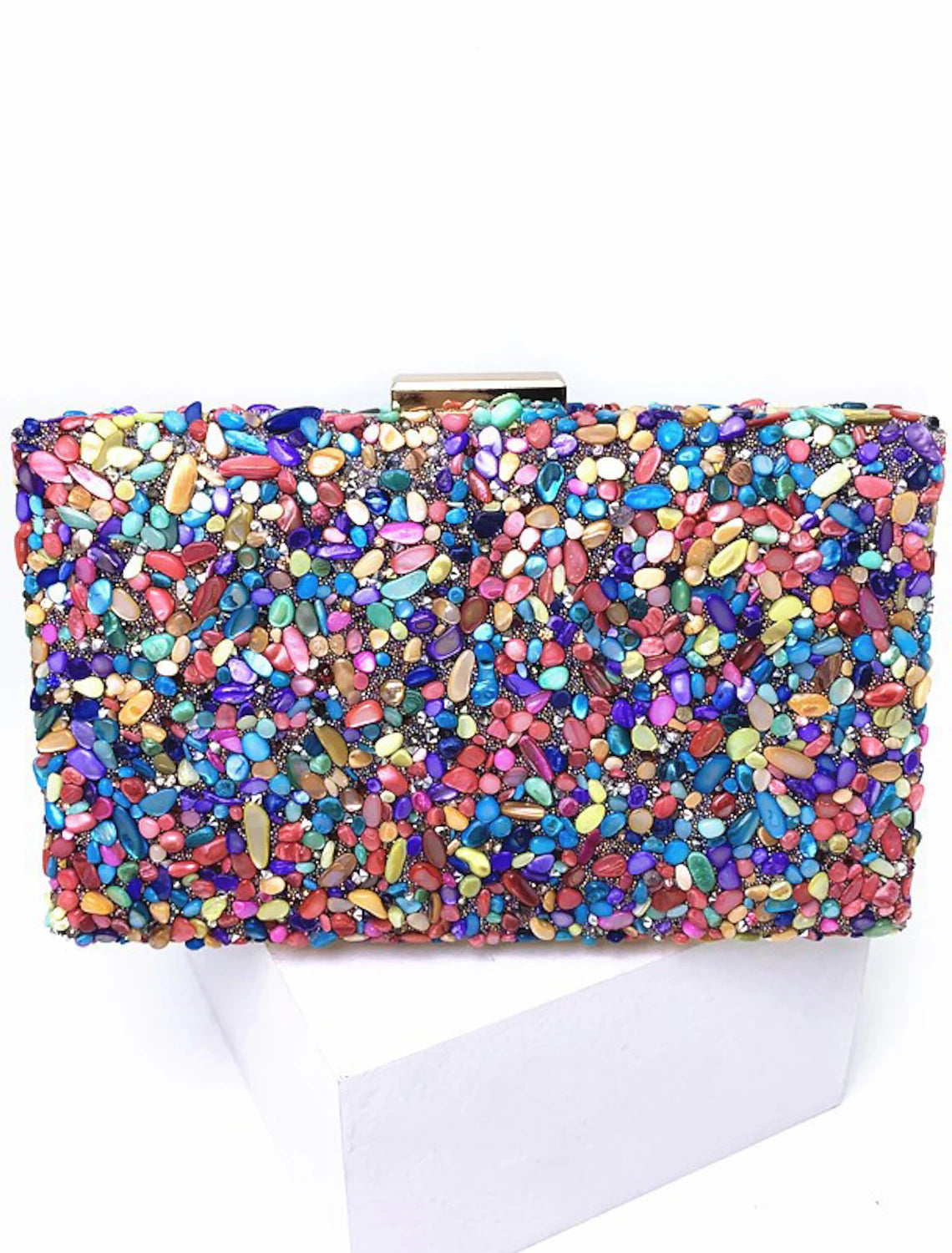Women's clutch bag with color block pattern, held open.