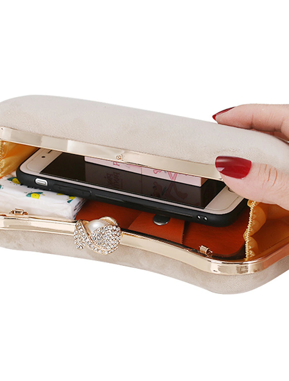 Corduroy clutch bag styled with an elegant outfit for an evening event.
