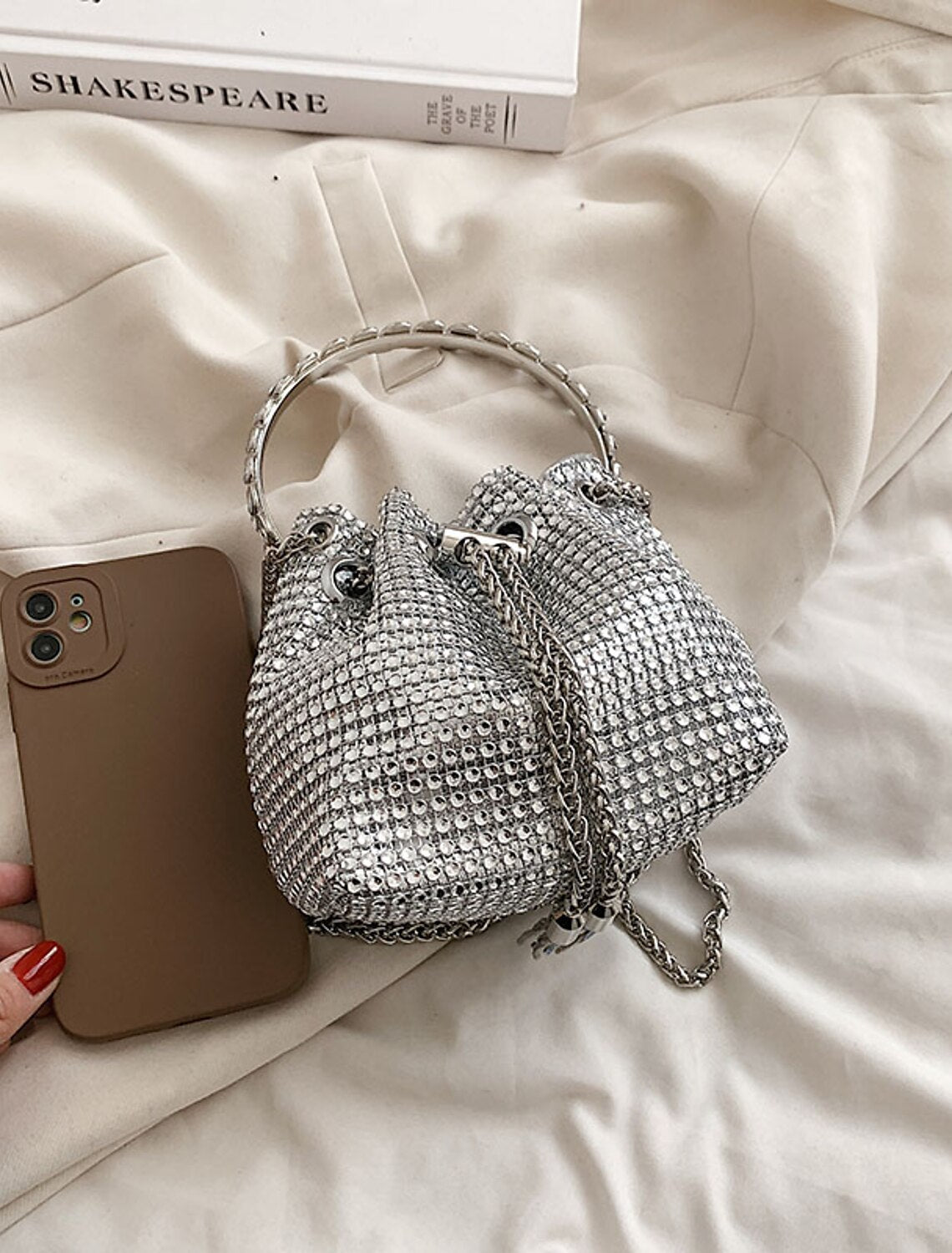 Elegant crystal evening bag held by a woman in a formal setting.