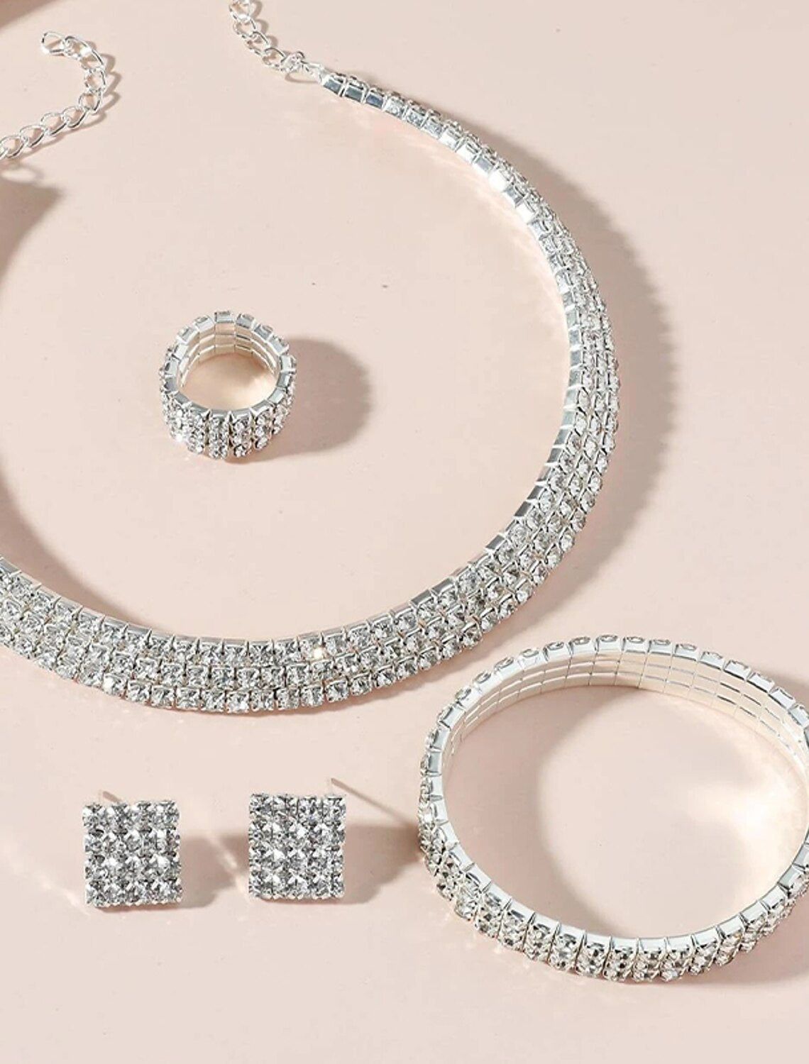 Detailed view of the chrome hoop earrings from the women's jewelry set.