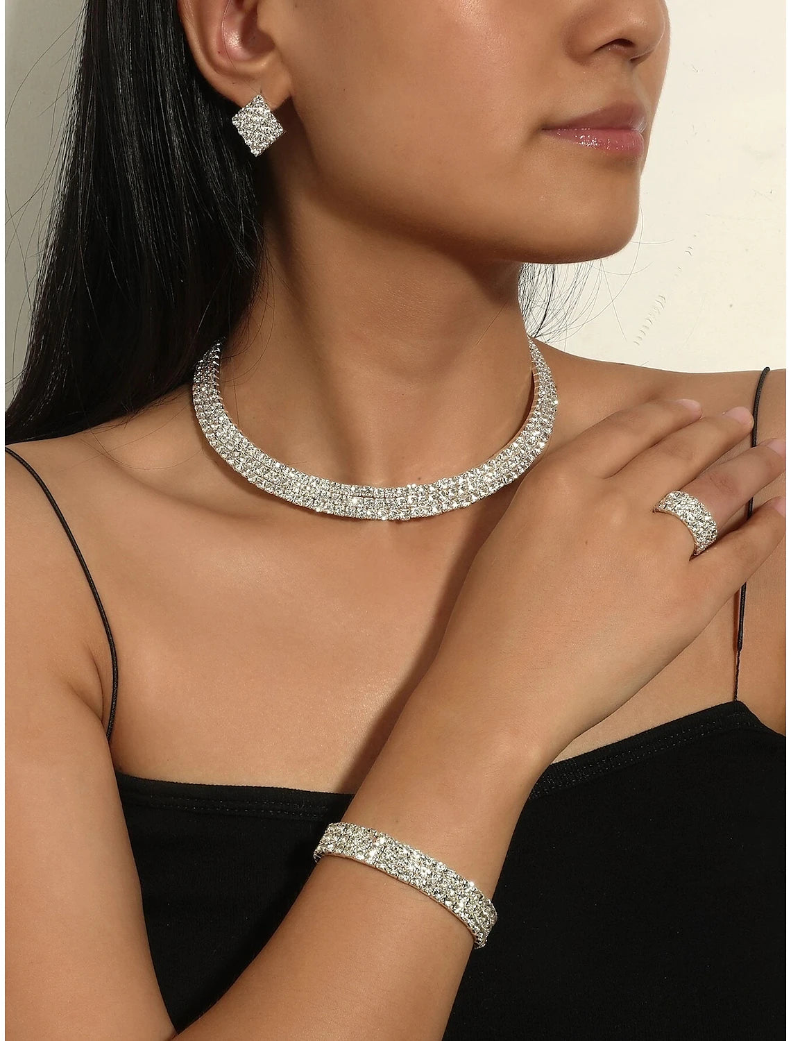 Complete chrome jewelry set for women, featuring necklace, bracelet, and multiple hoop earrings.