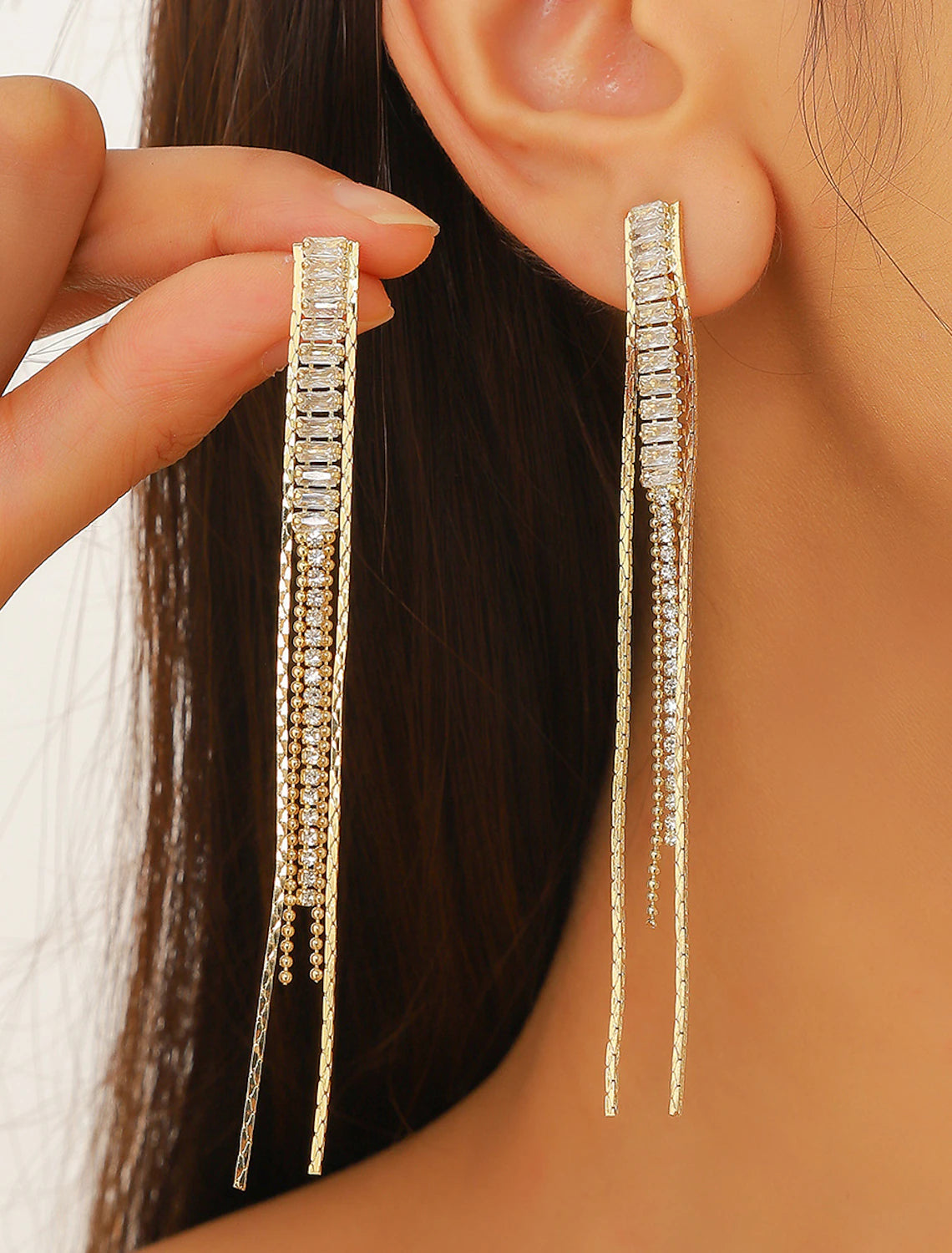 Women's brown drop earrings with gold-tone tassel fringe.