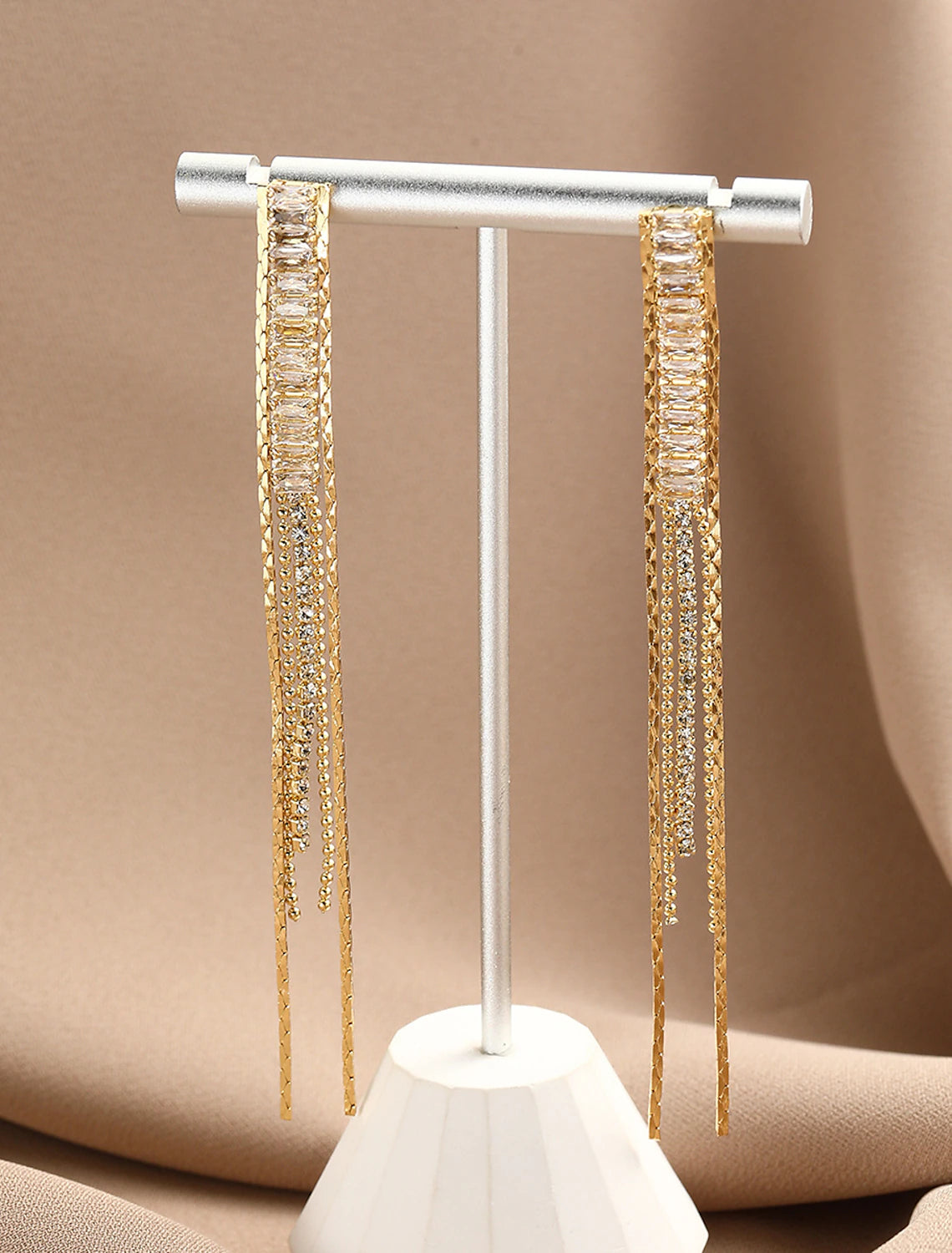 Stylish brown drop earrings with gold-tone fringe detail.