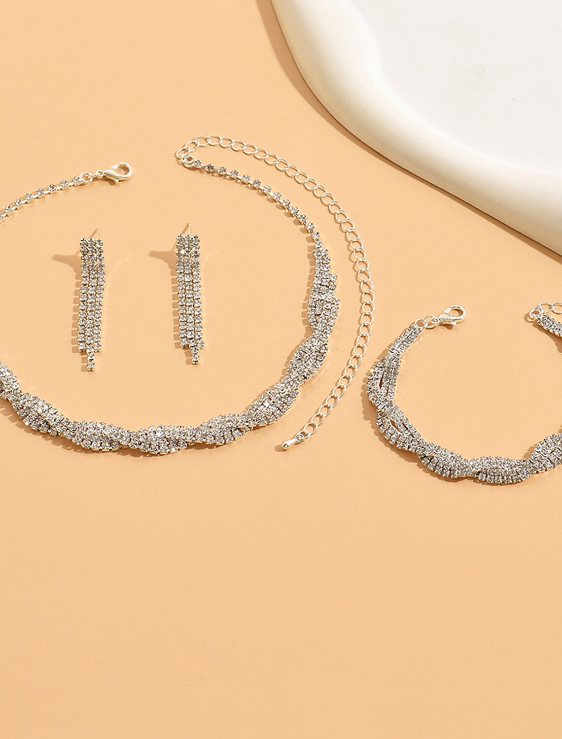 Elegant geometric alloy jewelry set for women, featuring a necklace and matching earrings, displayed on a model.