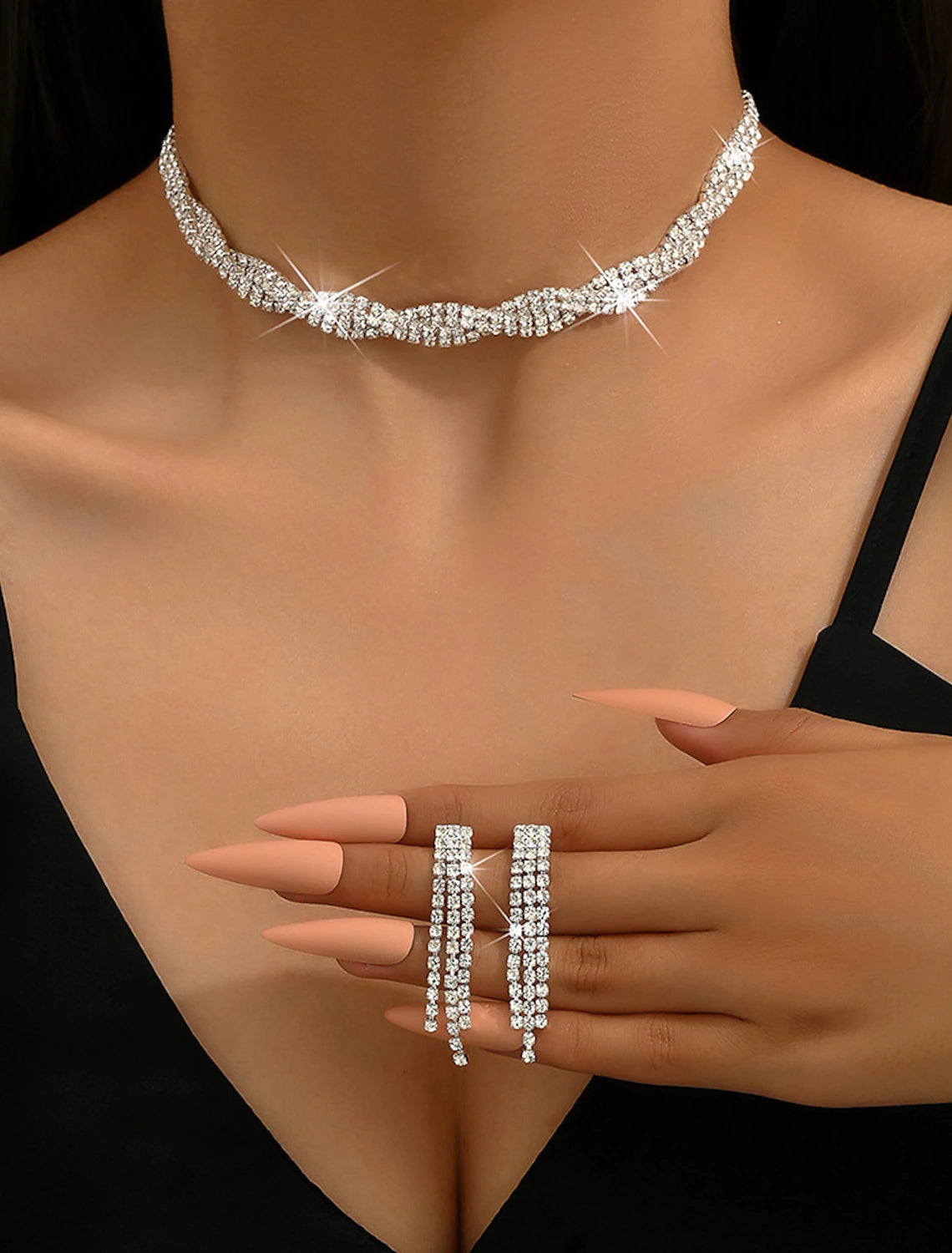 Close-up of the geometric alloy necklace and earrings from the 3-piece set.