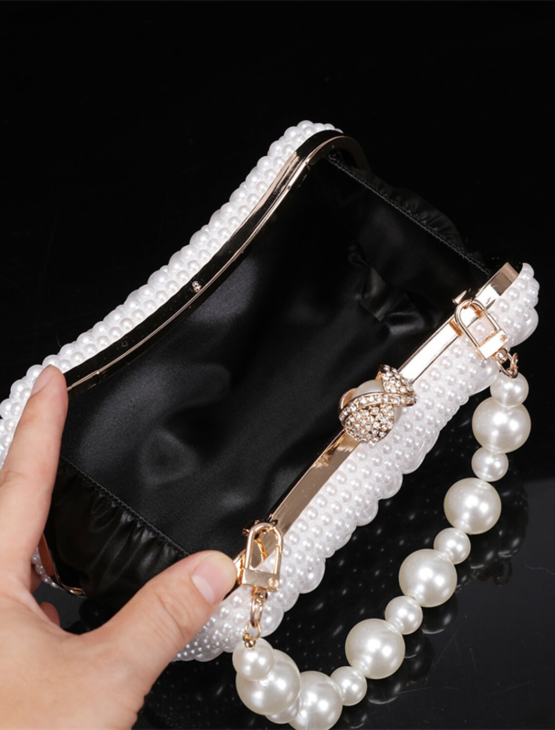 Detailed view of the geometric design on the leather clutch.
