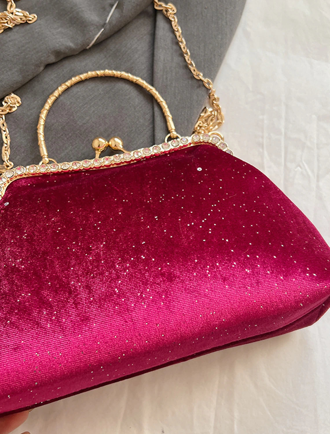 Geometric nylon clutch bag displayed from the front.