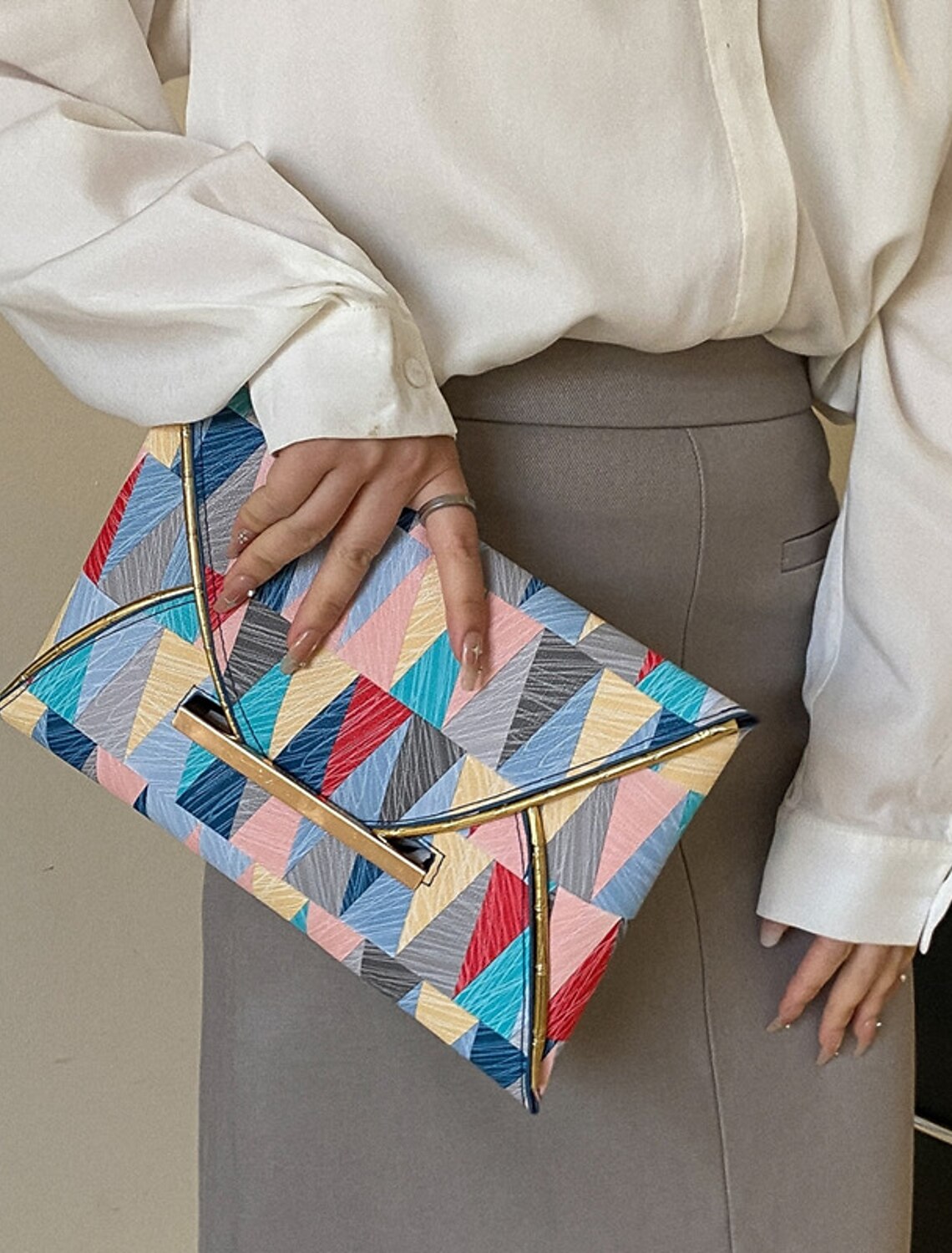 Back view of the lightweight geometric PU leather clutch bag.