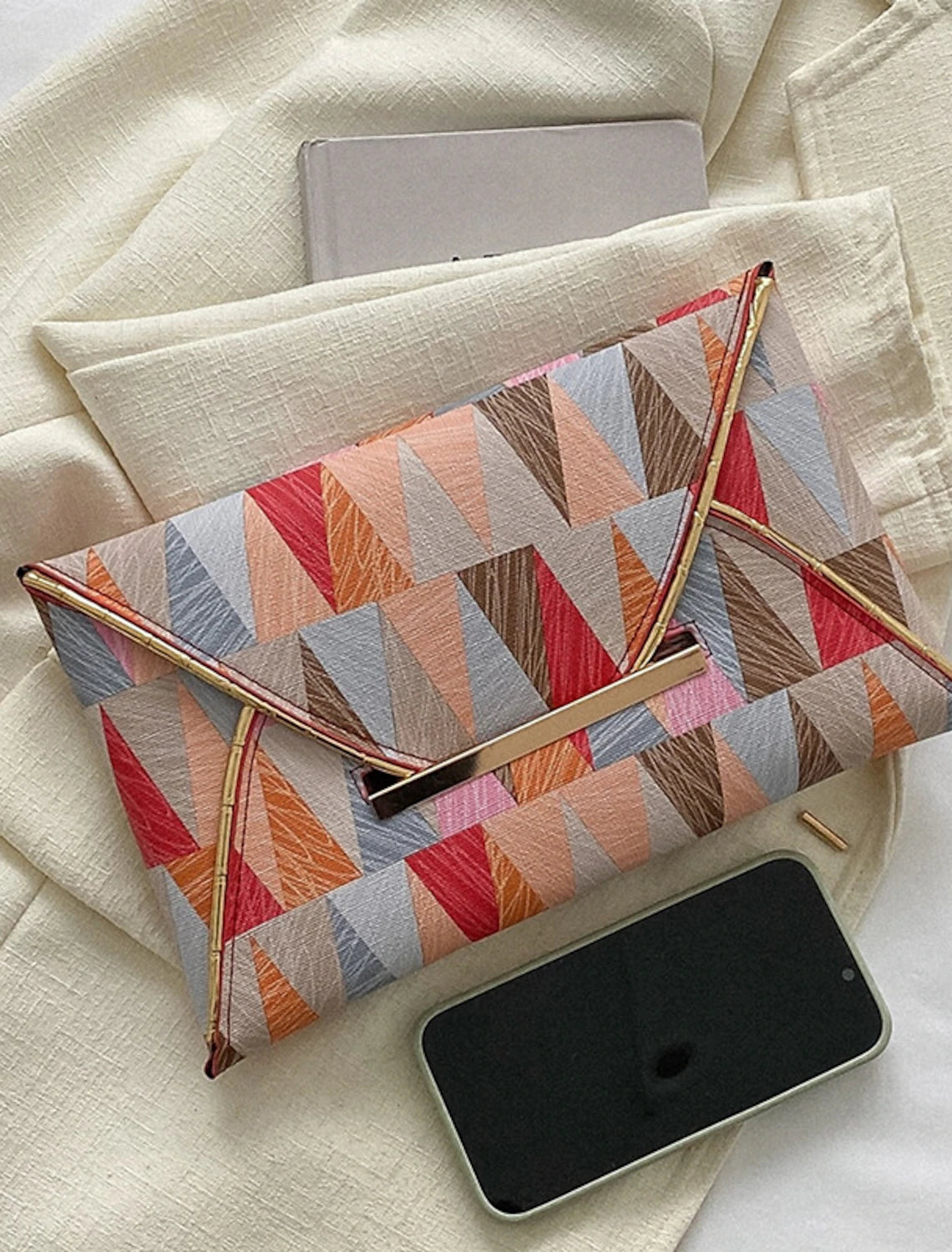 Woman holding the geometric PU leather evening clutch bag.