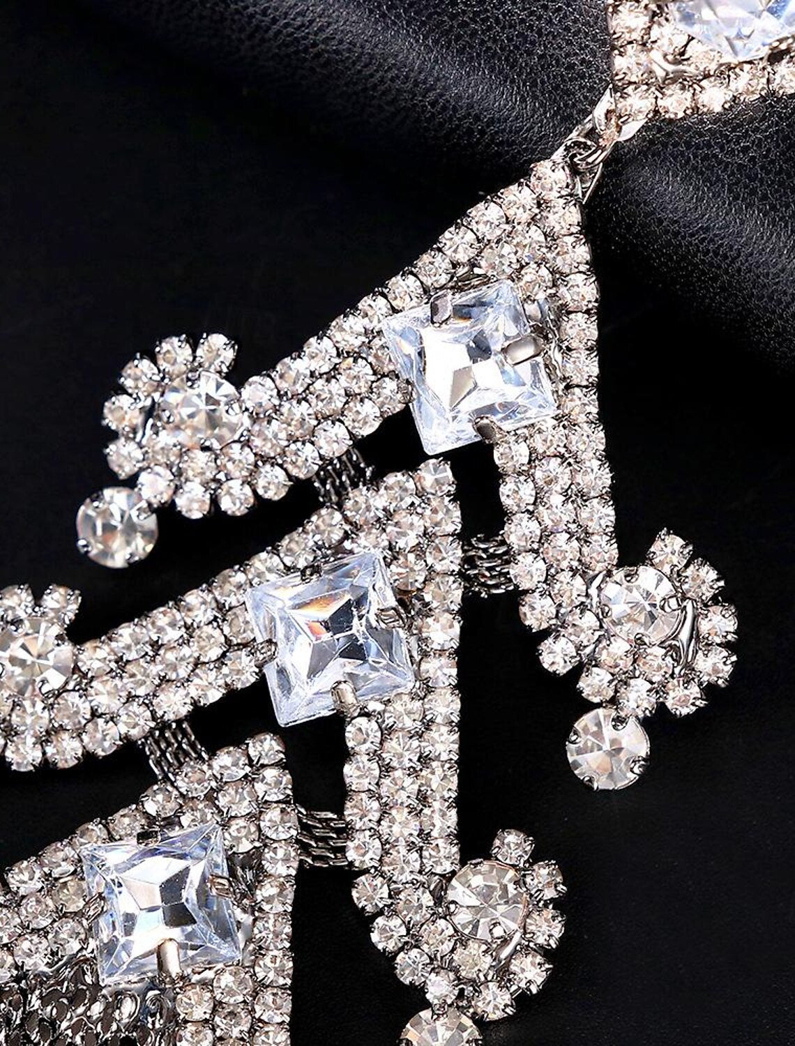 Pair of silver-tone geometrical vertical hoop earrings with sparkling imitation diamonds.
