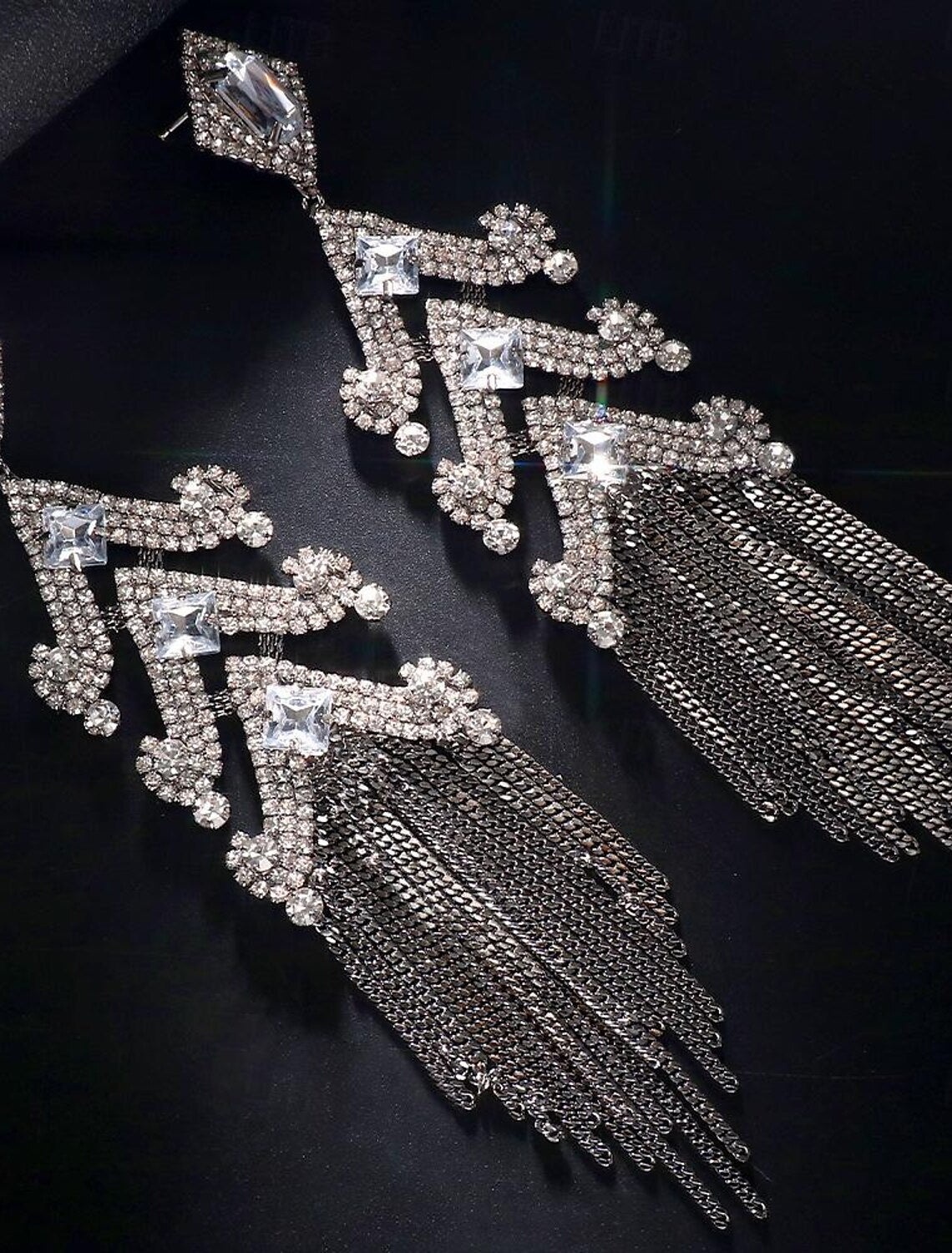 Close-up of the unique gold bar and imitation diamond detail on the hoop earrings.