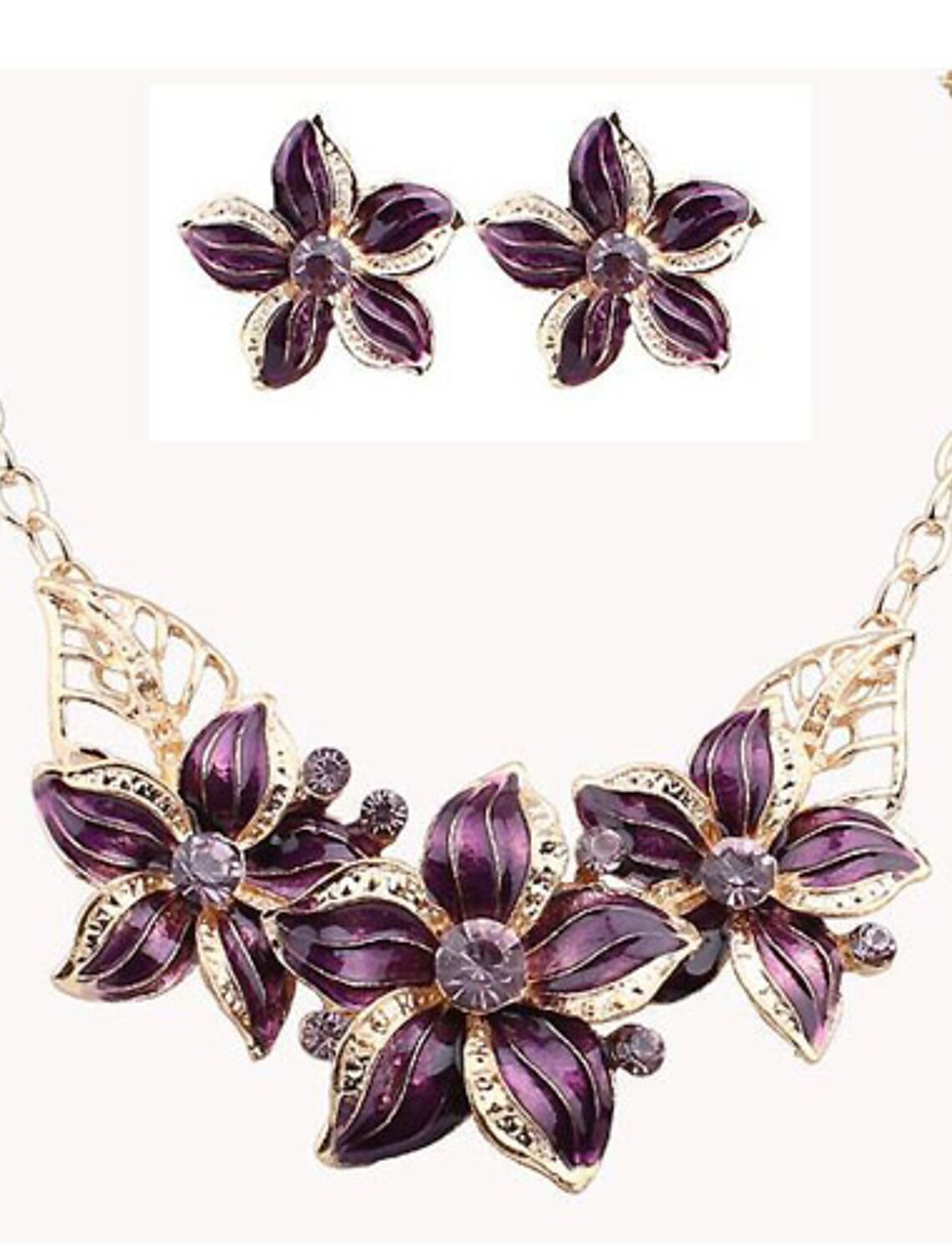 Women's gold tone jewelry set with flower design and synthetic diamonds.