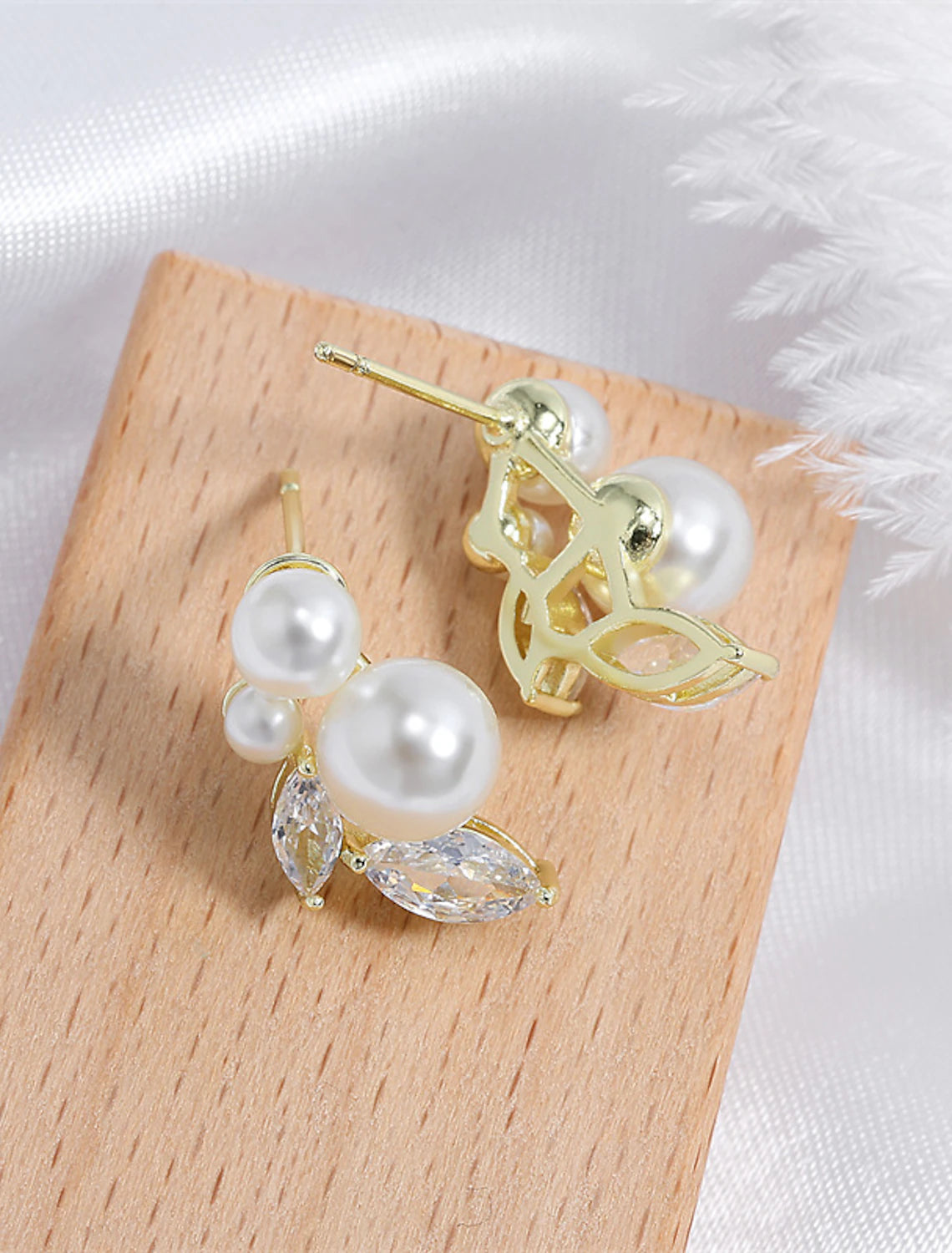 Stylish imitation pearl drop earrings with gold-tone accents.