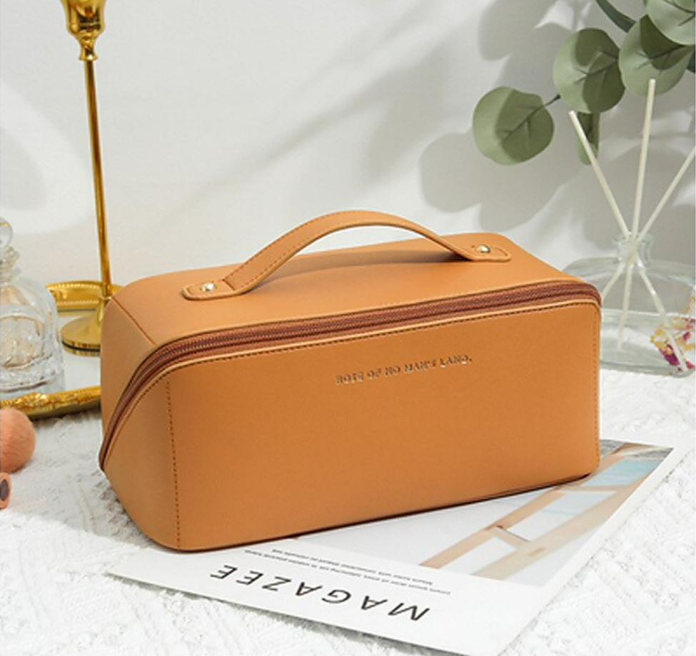 A women's portable cosmetic bag, closed, with a side view.
