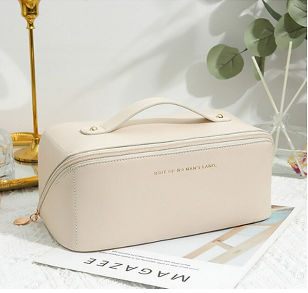 An open travel wash bag for women, displaying its organized sections.