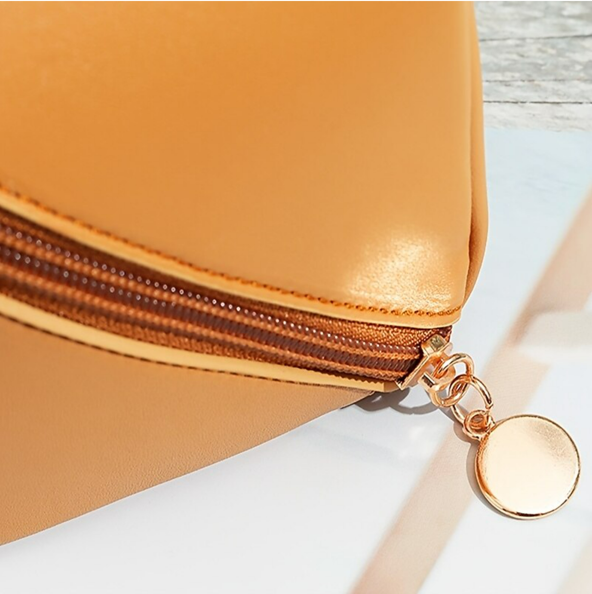 A women's large capacity cosmetic bag, open, filled with various beauty products.