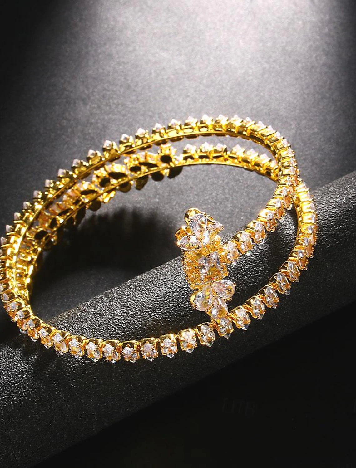 Close-up of the sparkling rhinestones on a silver tennis bracelet.