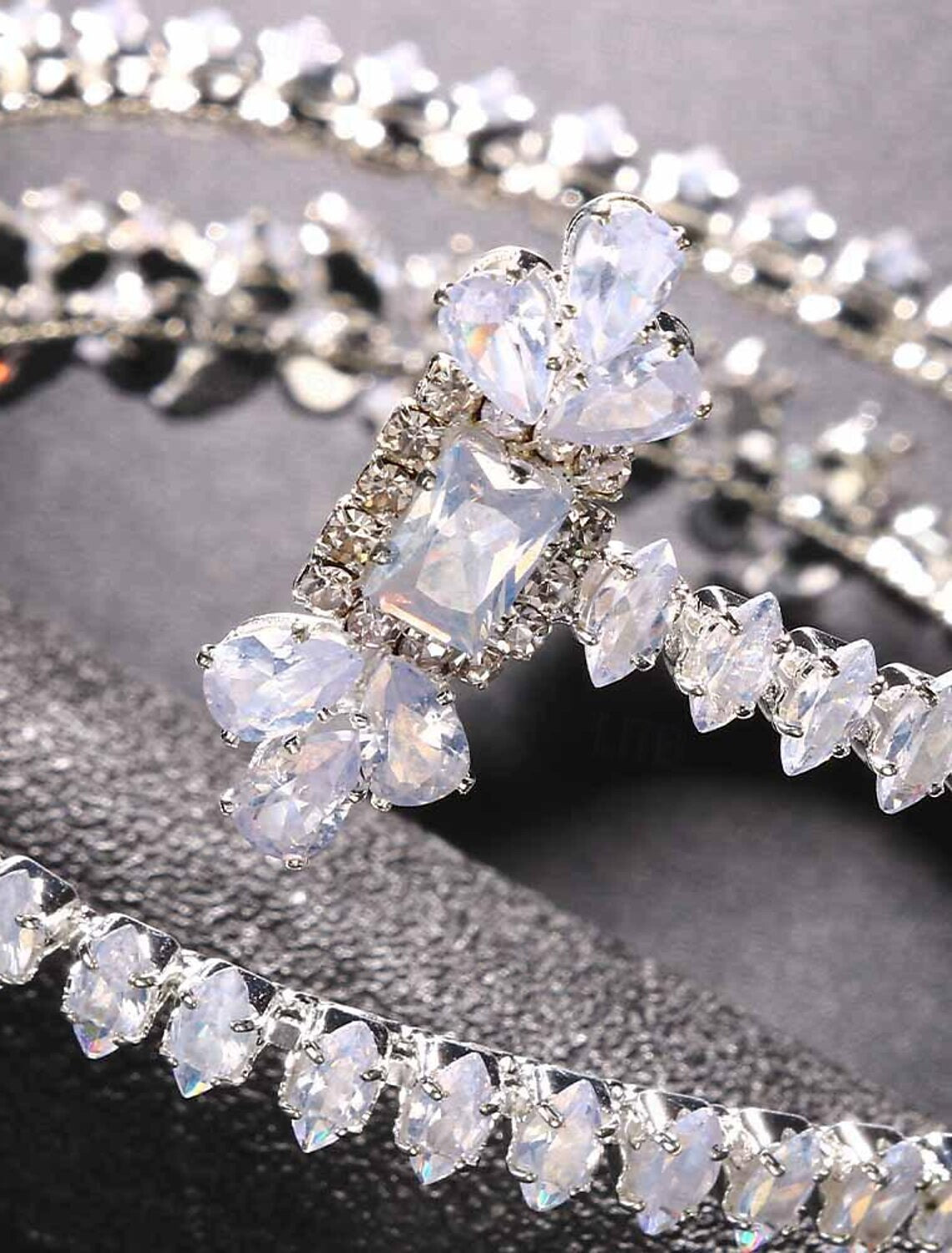 Detailed view of the clasp and rhinestone setting on a tennis bracelet.