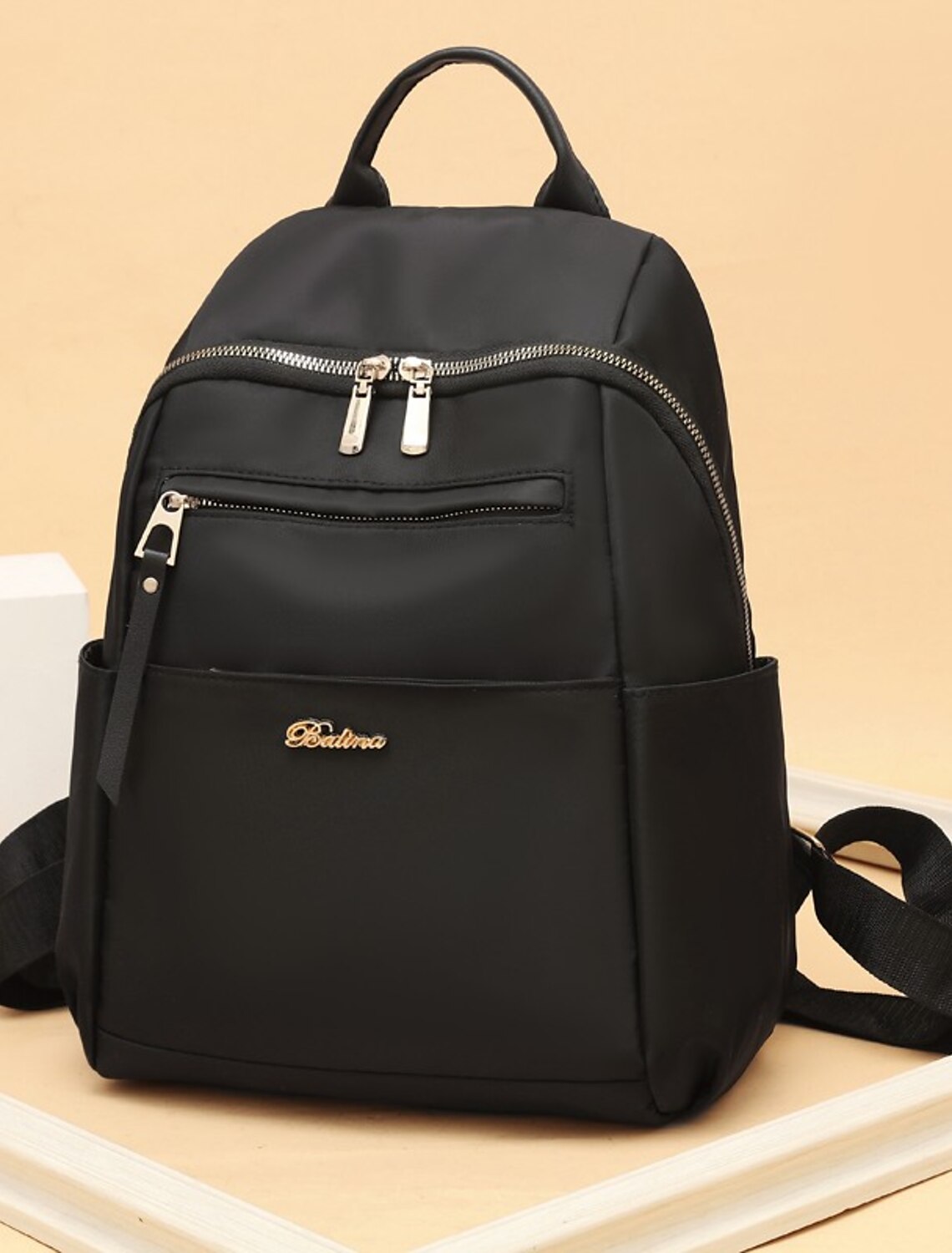 Women's Oxford Cloth backpack in black, featuring a large main compartment and front zipper pocket.