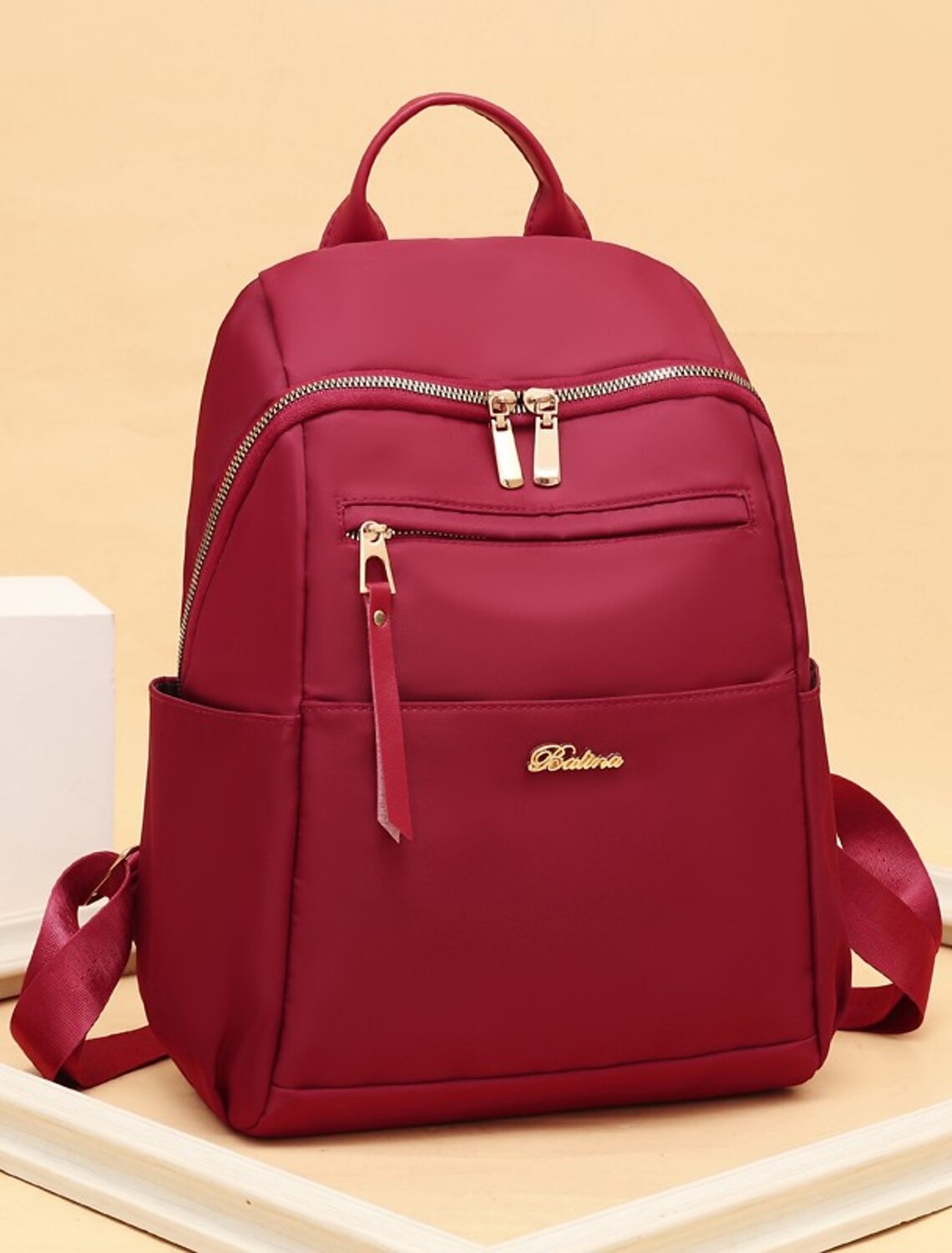 Woman wearing a black Oxford Cloth backpack, demonstrating its comfortable fit and practical size.