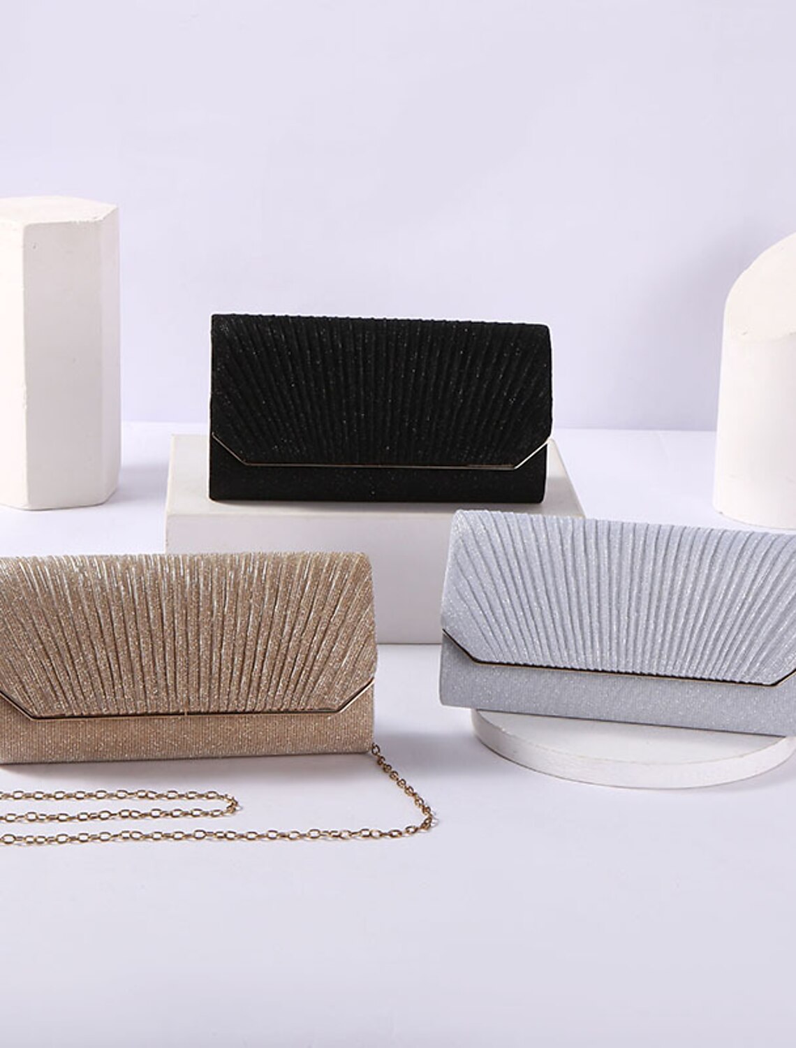 Black PU leather clutch evening bag with a gold chain strap.