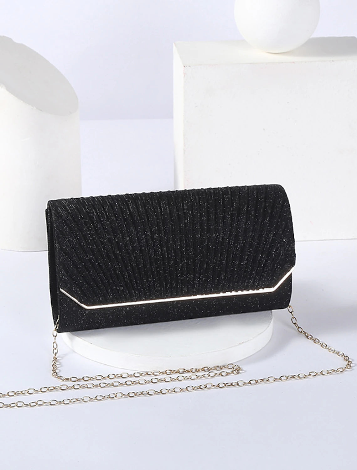 Side view of a black PU leather clutch bag, showing its depth.