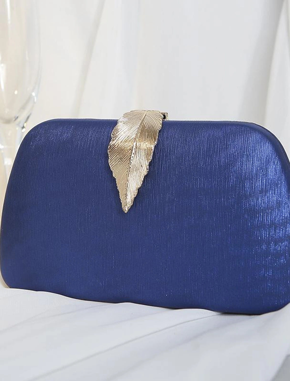 Close-up of the buckle chain detail on the clutch bag.
