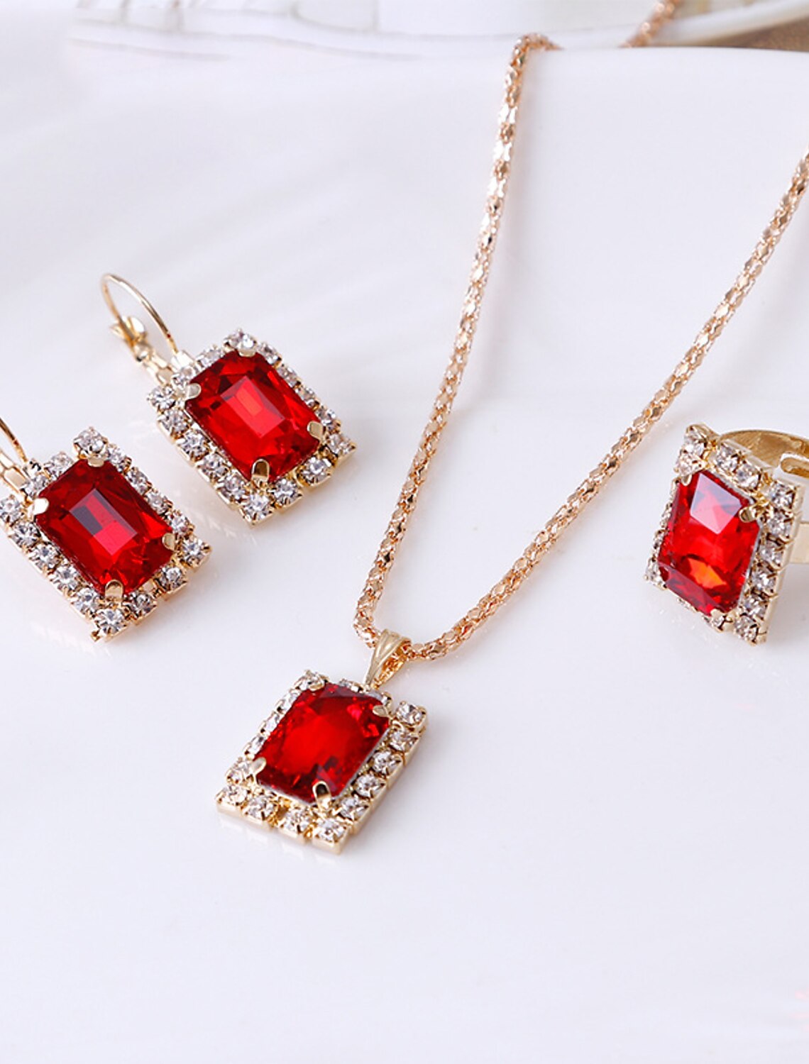 Women wearing the rhinestone alloy jewelry set, featuring hoop earrings, necklace, and ring.