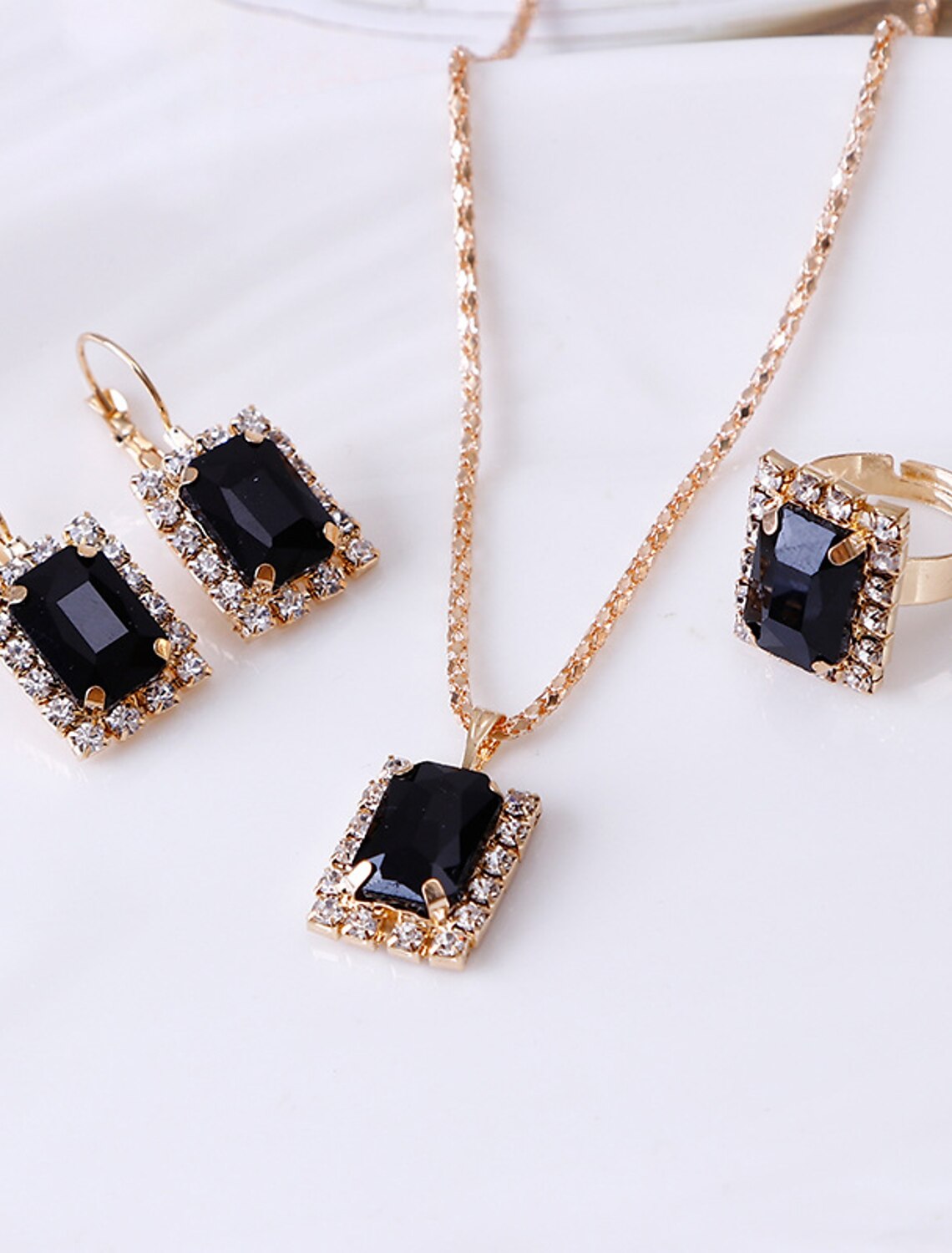 Close-up of the rhinestone alloy necklace and hoop earrings from the jewelry set.