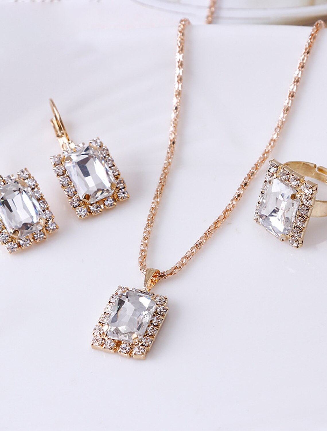 Rhinestone alloy hoop earrings with geometric design.