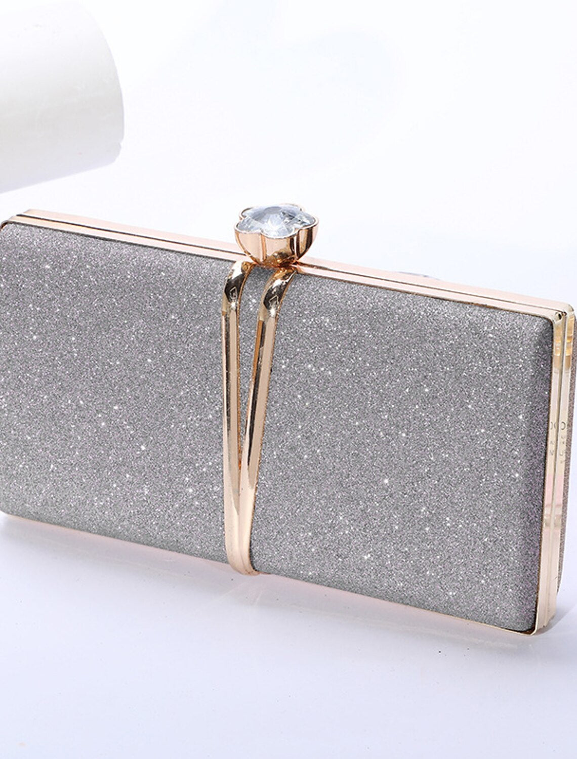 Women's rhinestone clutch evening bag with a silver chain.