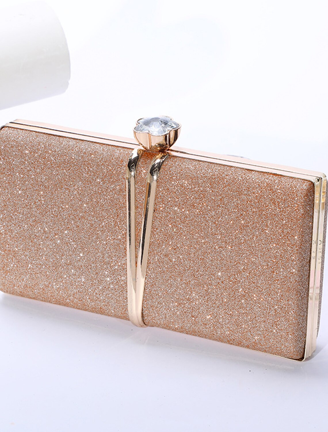 Close-up of the sparkling rhinestone detailing on a women's clutch.