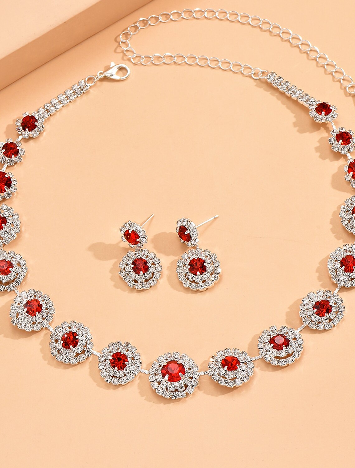 Woman wearing rhinestone geometric necklace and earrings.