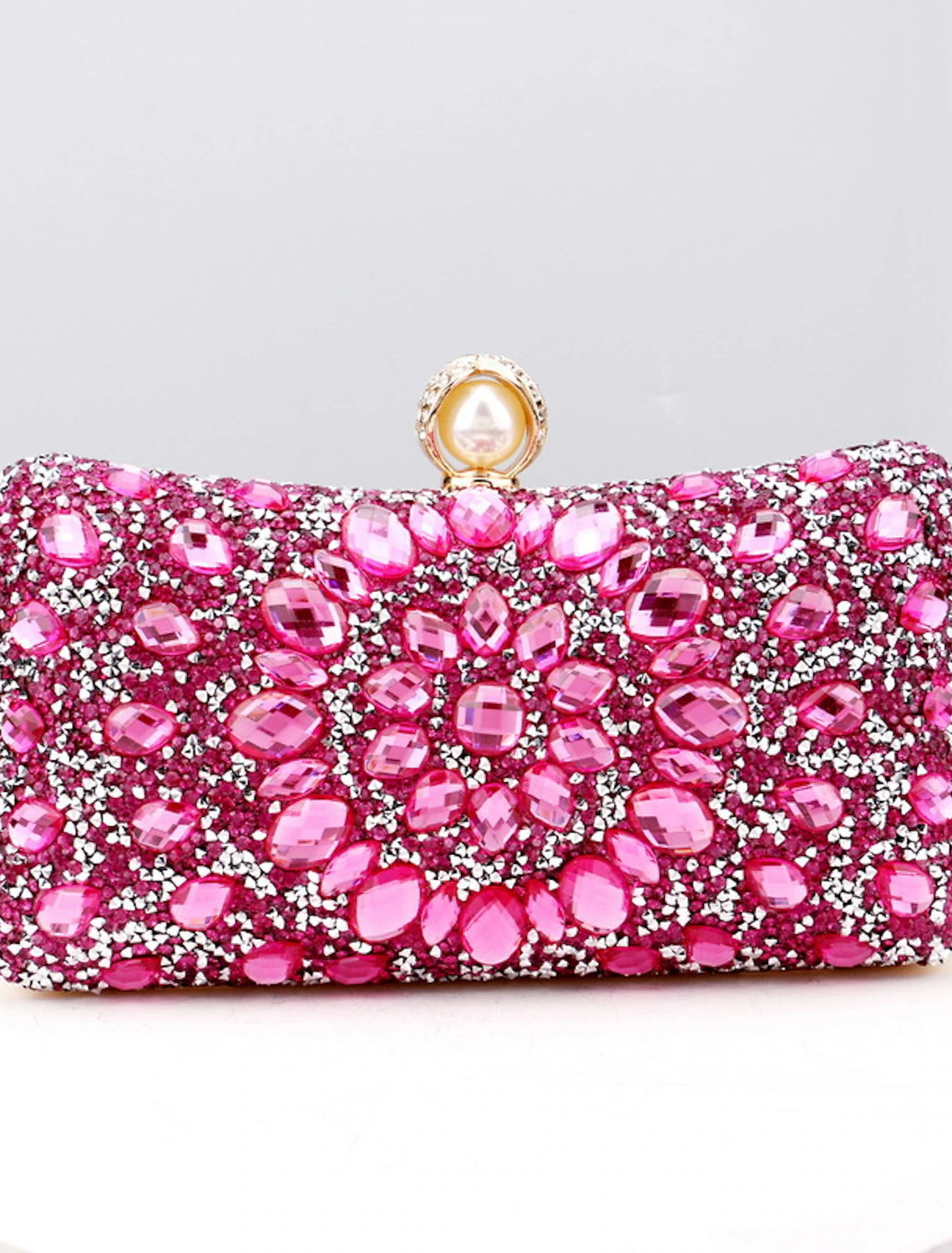 Women's rhinestone and pearl evening clutch bag with a chain strap.