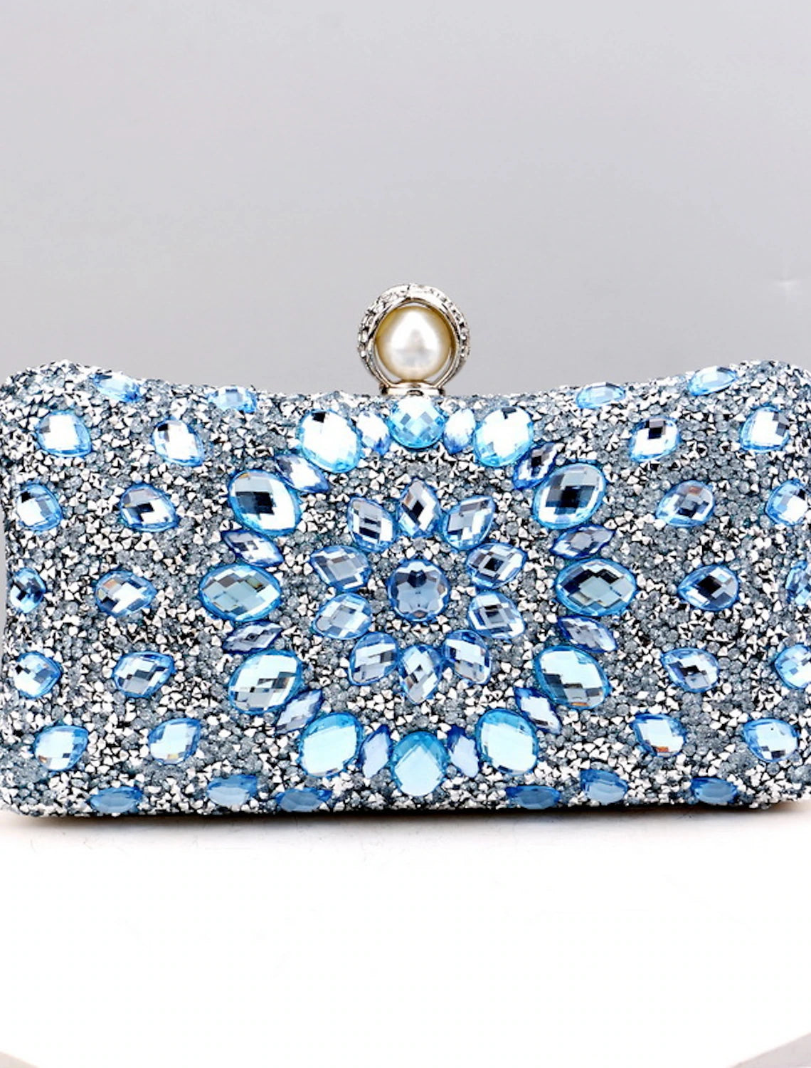 Women's rhinestone and pearl evening clutch bag with a chain strap.