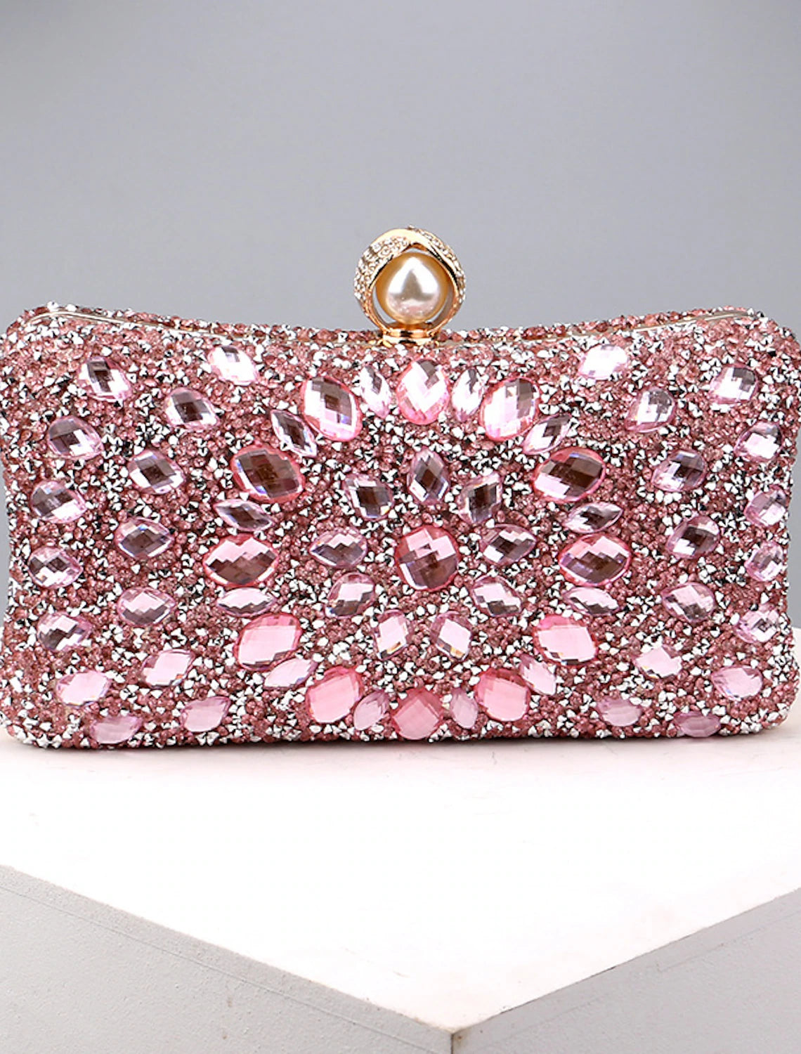 Women's rhinestone and pearl evening clutch bag with a chain strap.
