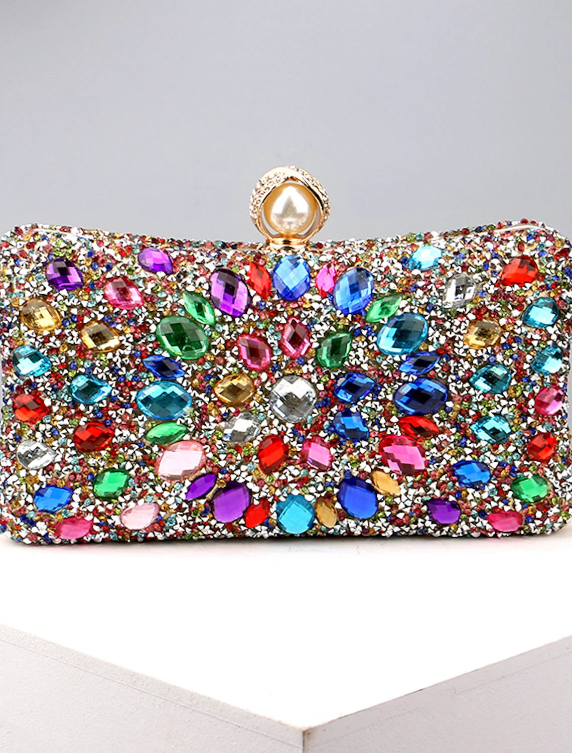 Women's rhinestone and pearl evening clutch bag with a chain strap.