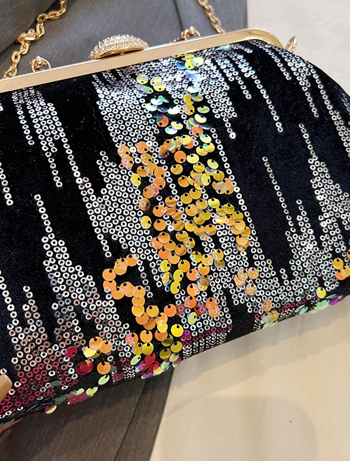 Close-up of sequin geometric dome clutch bag texture.