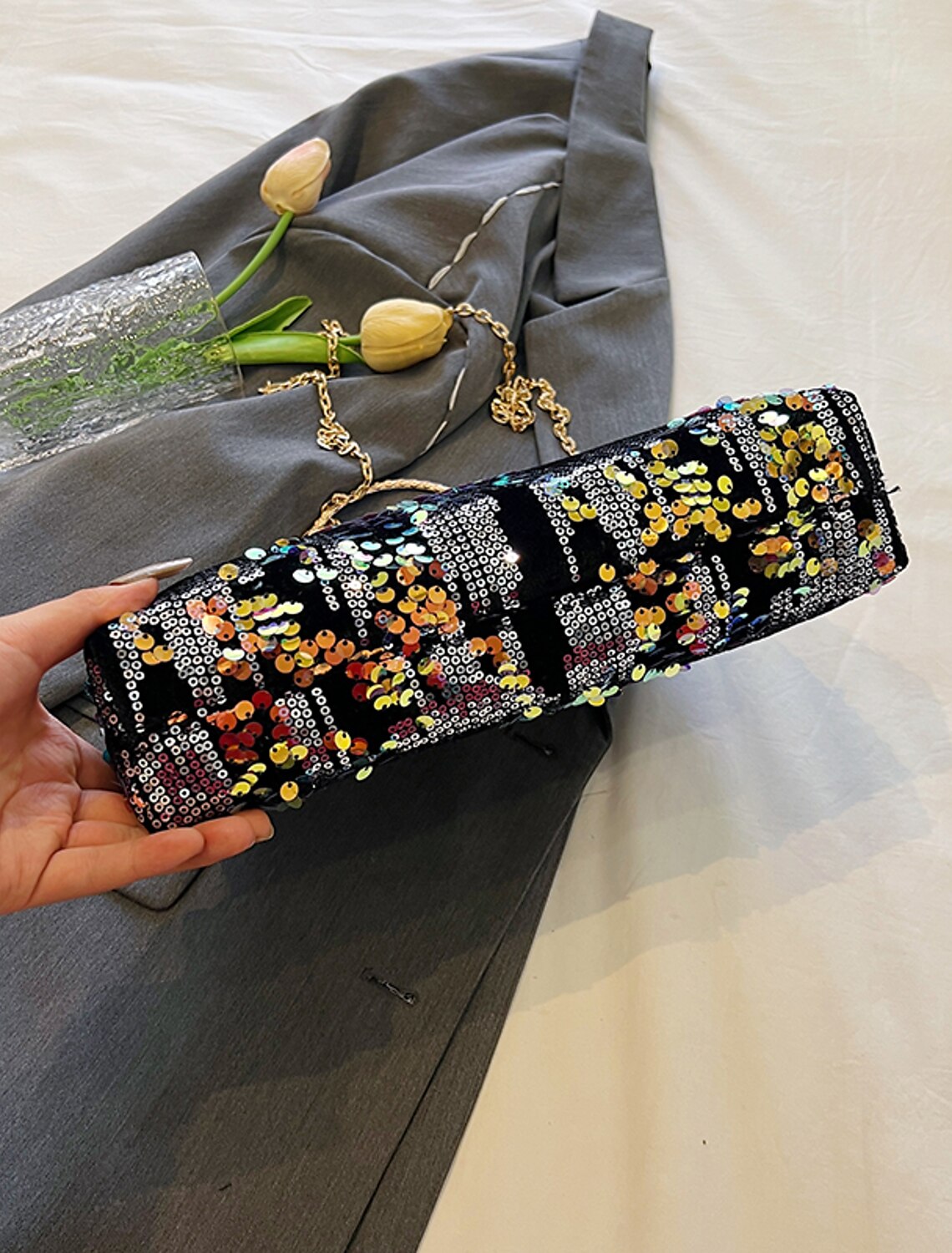 Sequin geometric dome clutch bag, side profile.